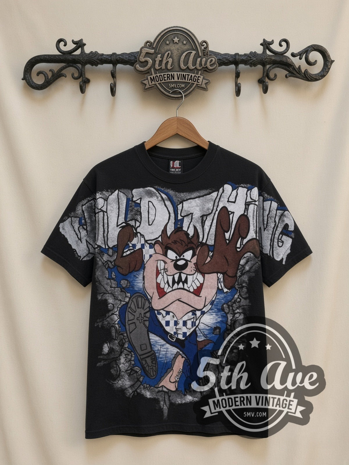 Looney Tunes Taz Wild Thing all-over-print vintage cartoon t-shirt in black, front view on a display rack