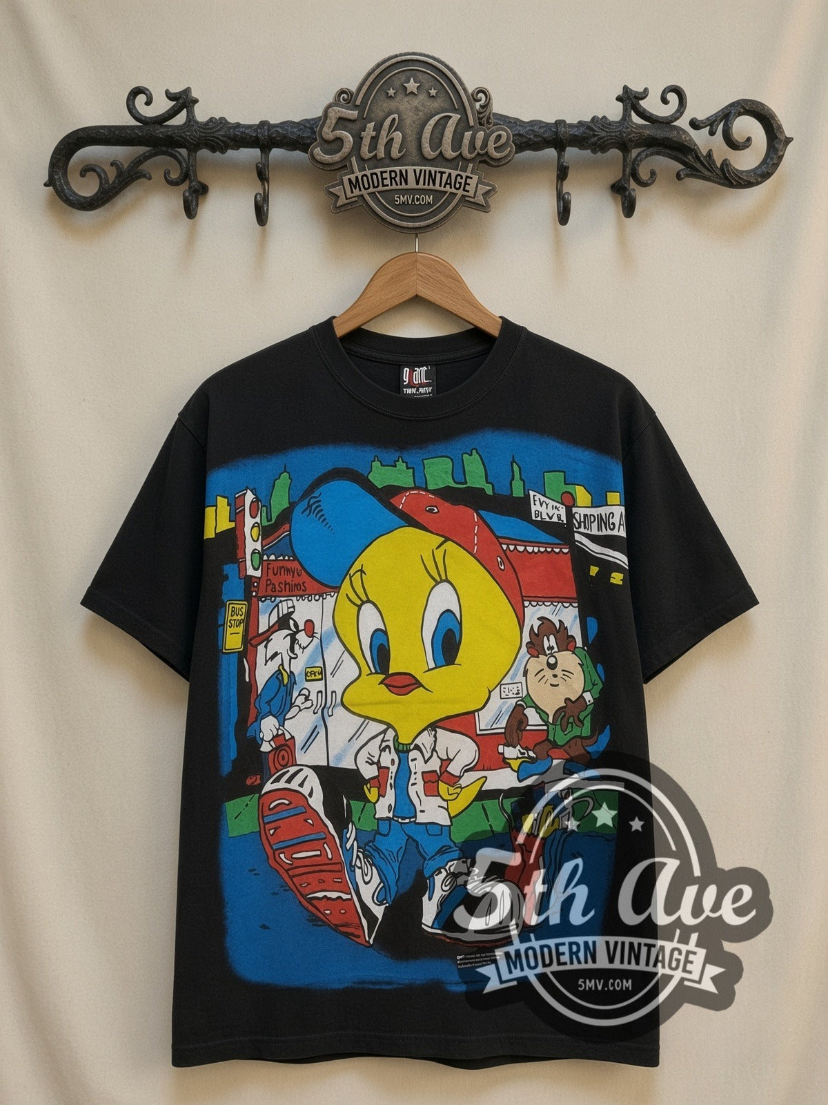 Looney Tunes Tweety Streetwear City all-over-print vintage cartoon t-shirt in black, front view on a display rack
