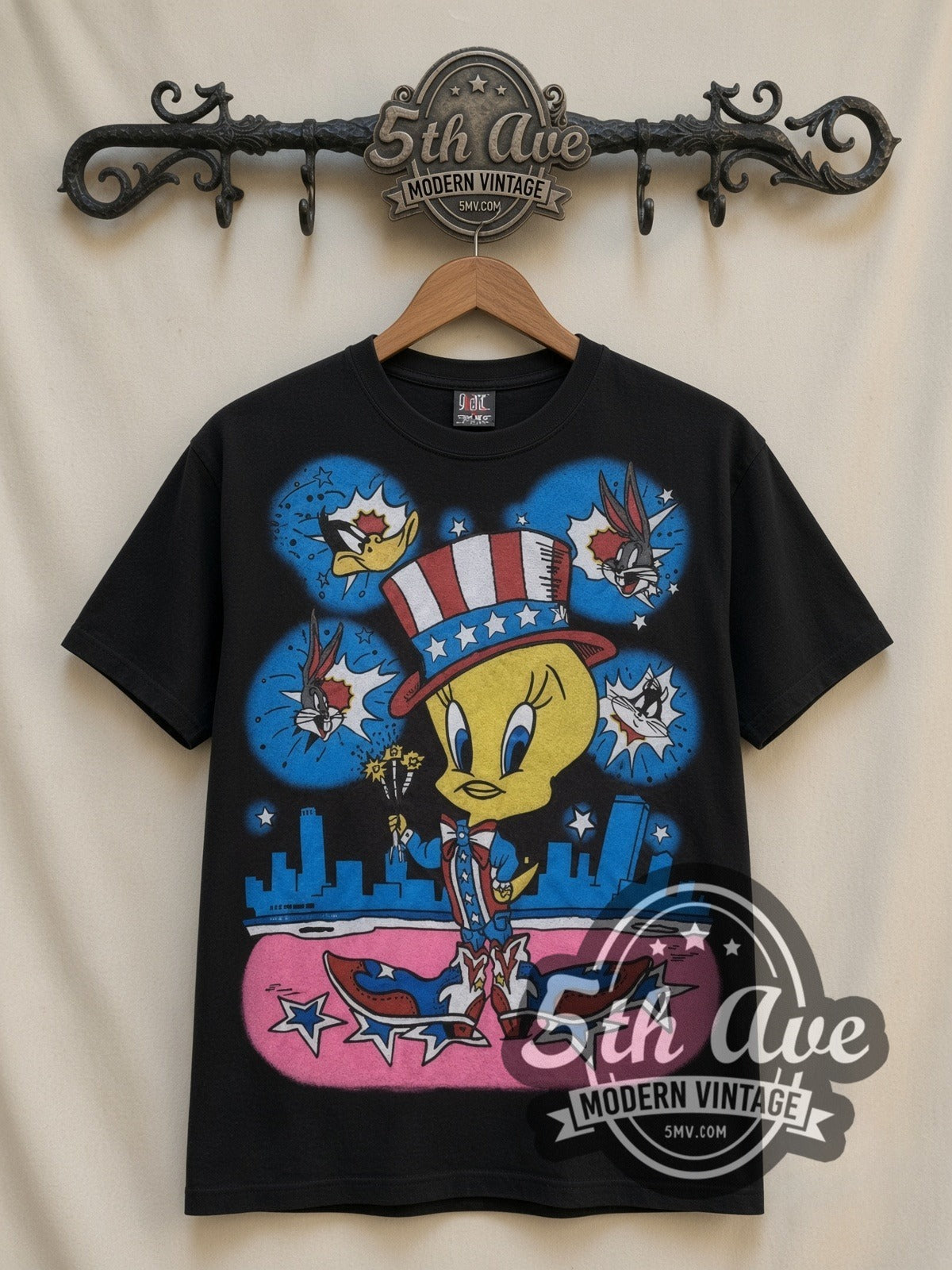 Looney Tunes Tweety Uncle Sam Patriotic all-over-print vintage cartoon t-shirt in black, front view on a display rack