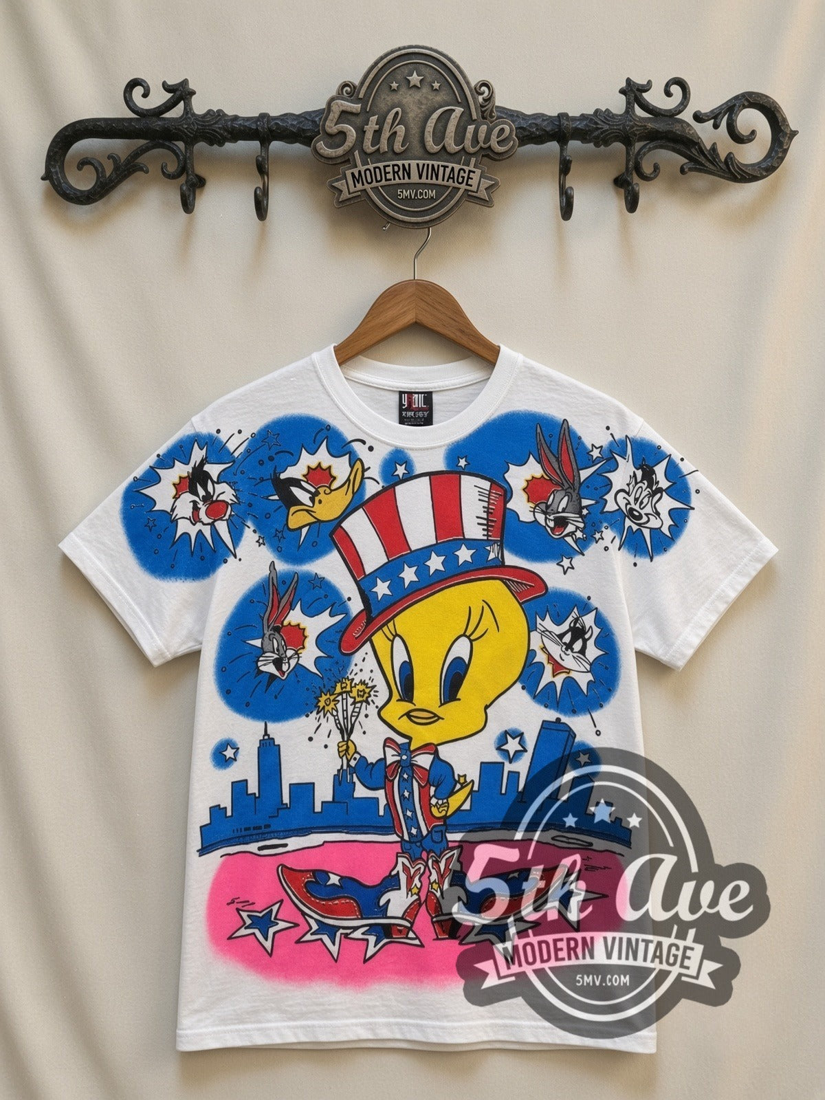 Looney Tunes Tweety Uncle Sam Patriotic all-over-print vintage cartoon t-shirt in white, front view on a display rack