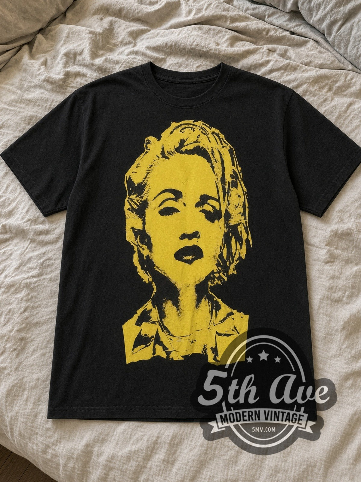 Black Madonna Yellow Portrait Vintage Band T-Shirt laid flat on a linen bed