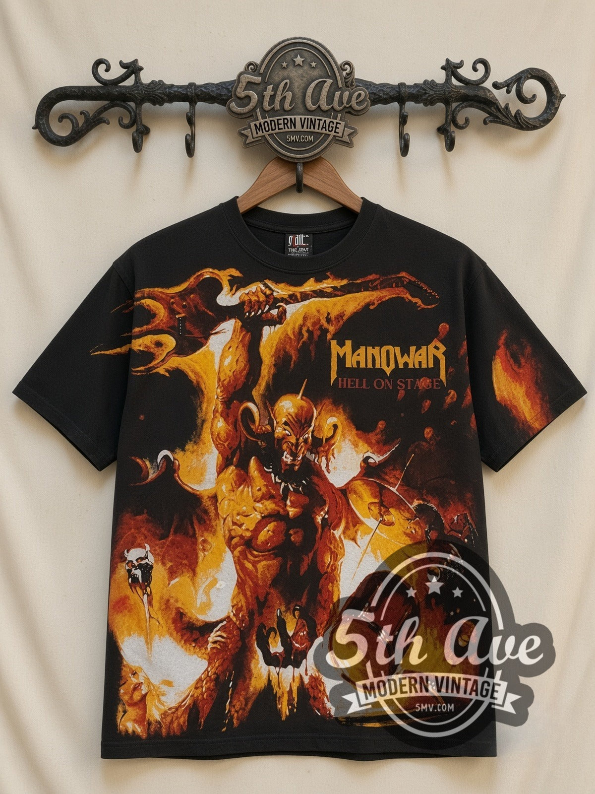 Manowar Hell on Stage all-over-print vintage band t-shirt in black, front view on a display rack