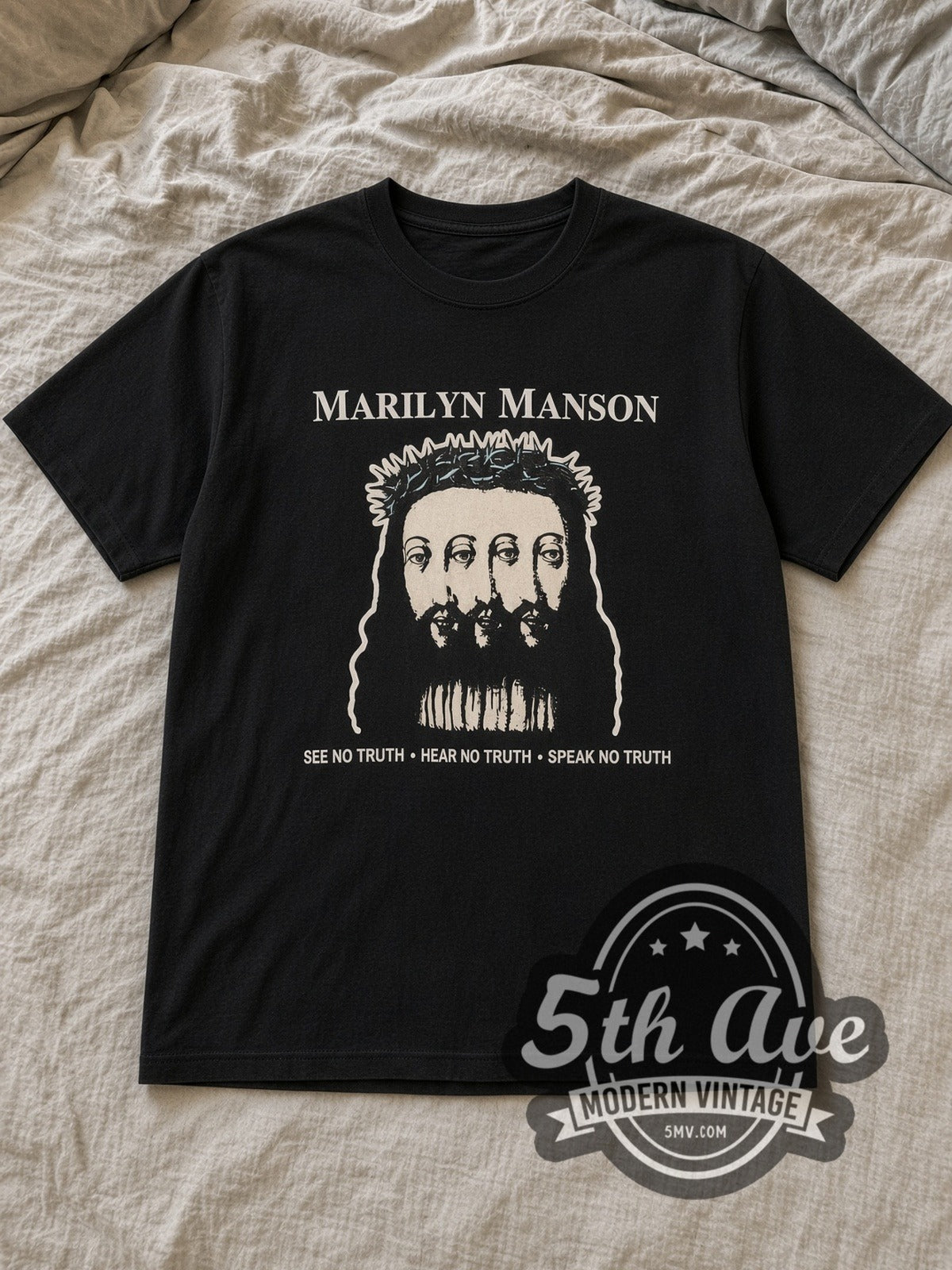 Black Marilyn Manson Believe Vintage Band T-Shirt laid flat on a linen bed