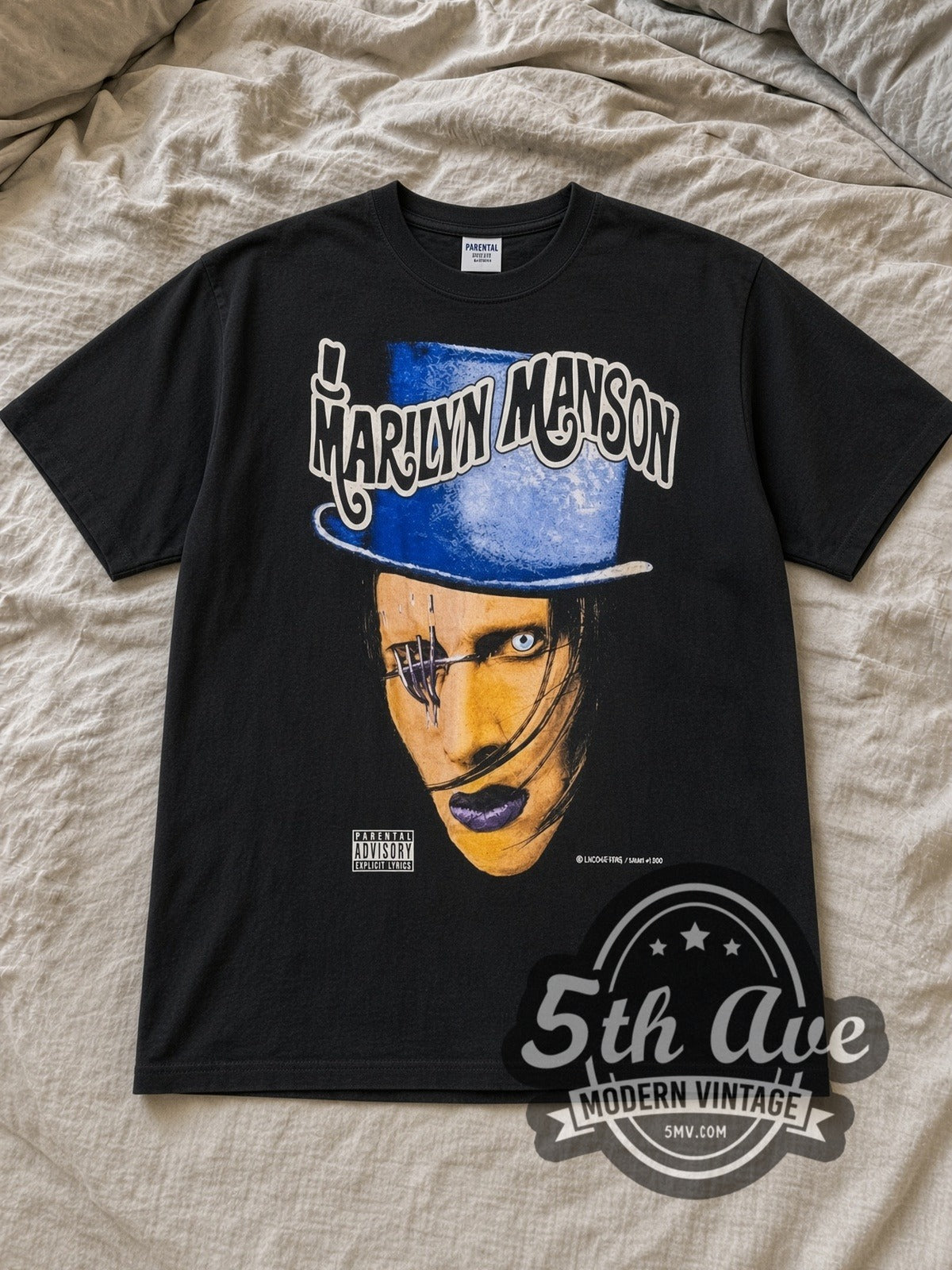 Black Marilyn Manson Dope Hat Vintage Band T-Shirt laid flat on a linen bed