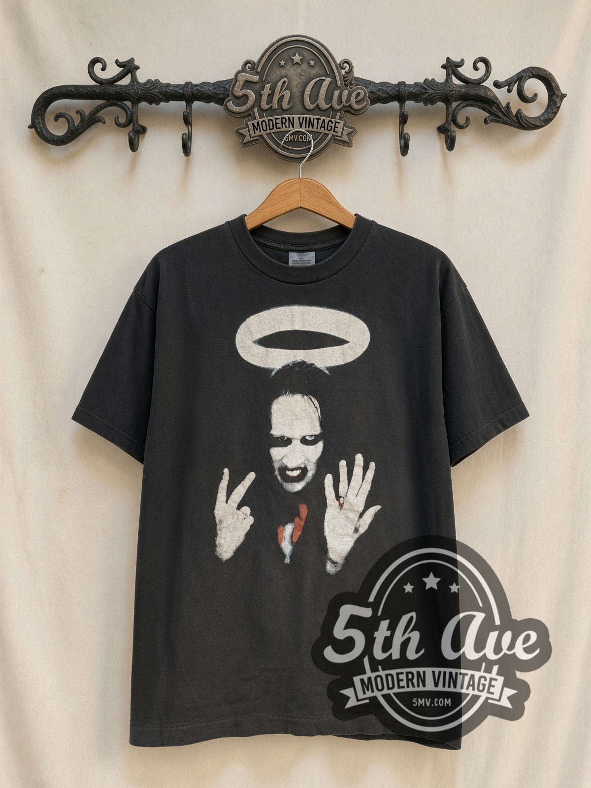 Marilyn Manson Halo Middle Fingers vintage band t-shirt, front view on a display rack