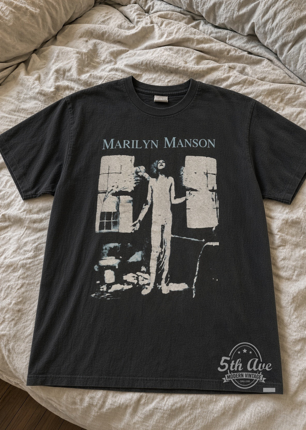 Marilyn Manson Photo Front Winged Skeleton Back vintage band t-shirt laid flat on bed