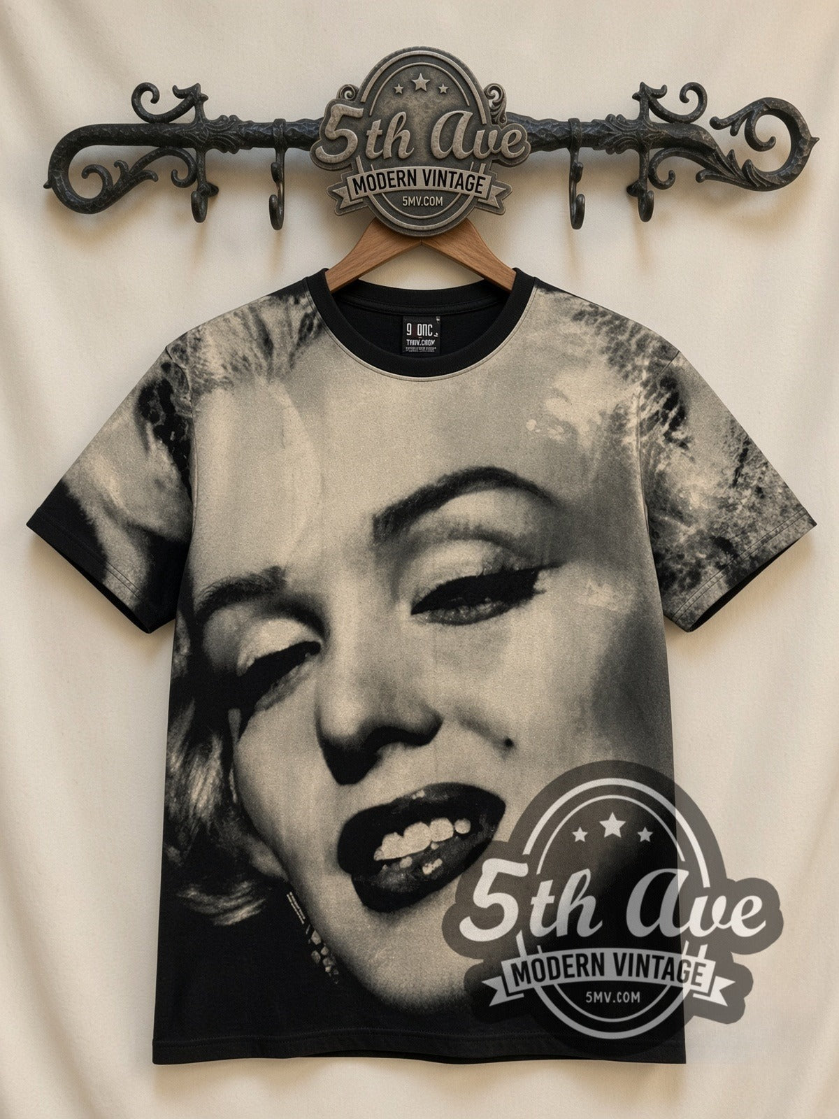 Marilyn Monroe Face Closeup all-over-print vintage graphic tee in black, front view on a display rack