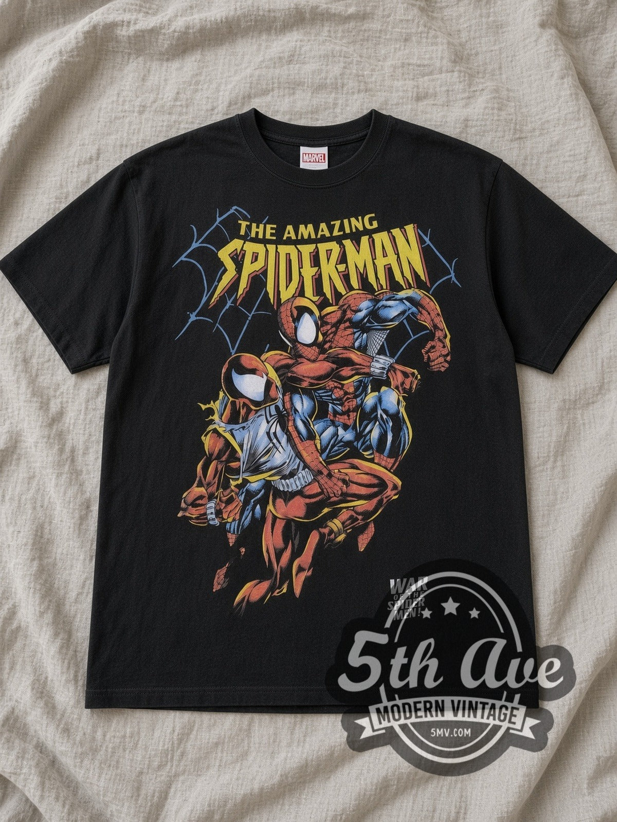 Black Spider Man All Over Print Graphic Vintage Comic T Shirt laid flat on a linen bed