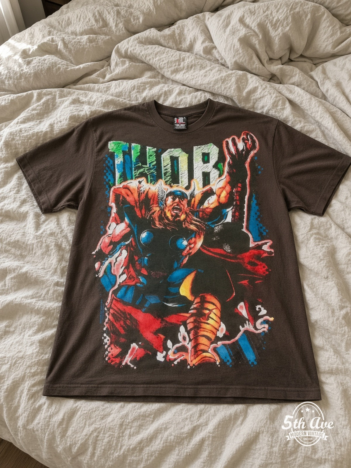 Marvel Thor Comic Action vintage tee laid on bed