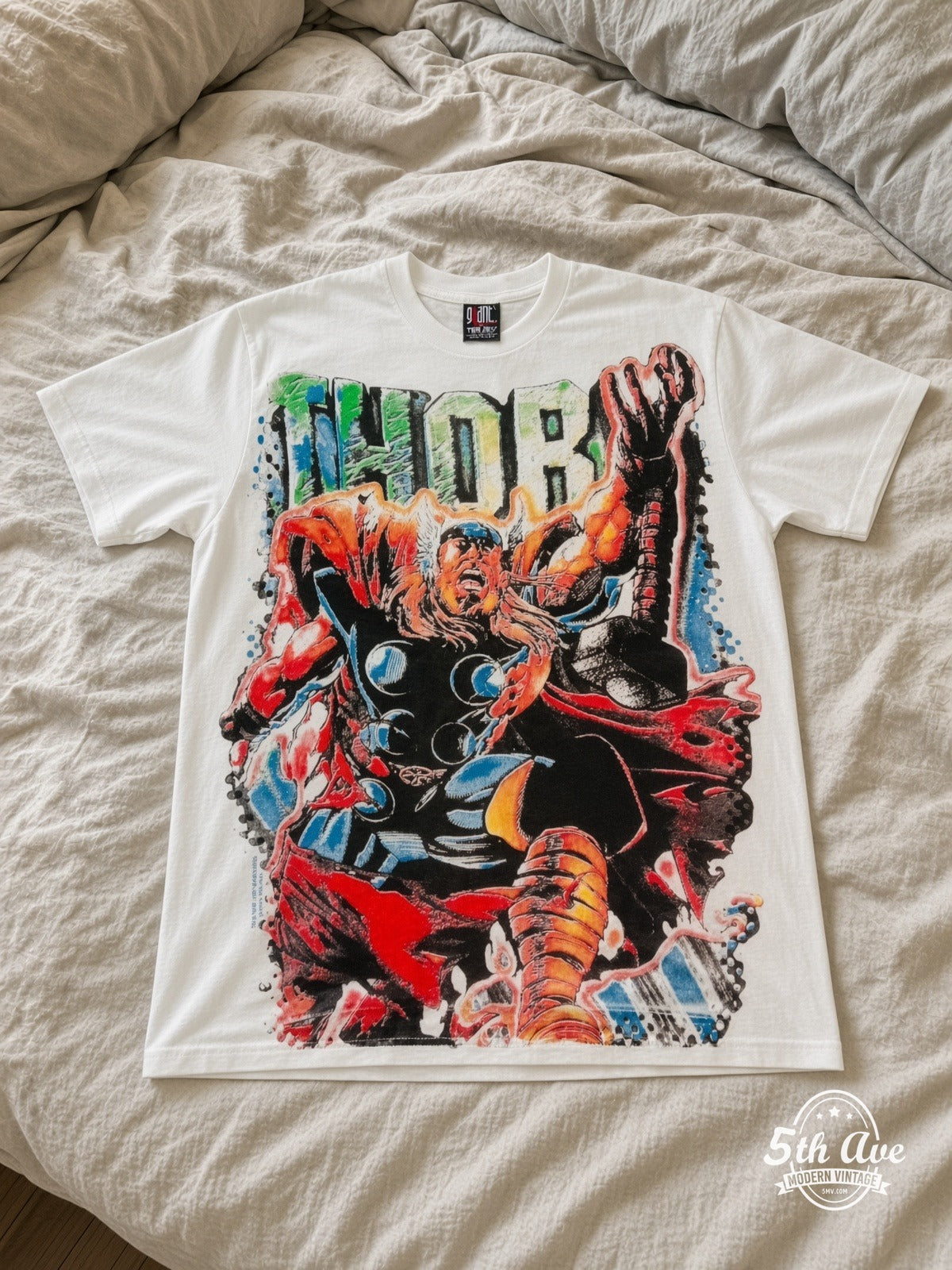 Marvel Thor Comic Action vintage tee laid on bed