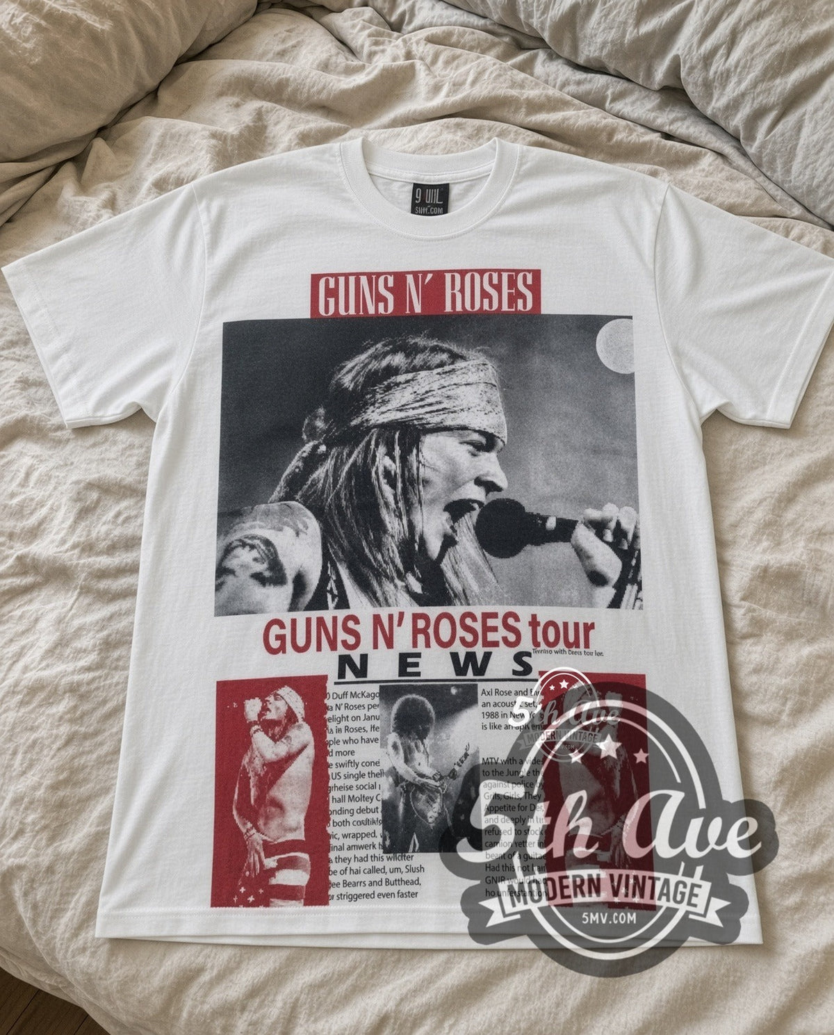 Guns N Roses Tour NEWS vintage band t-shirt in white laid flat on a bed, front artwork