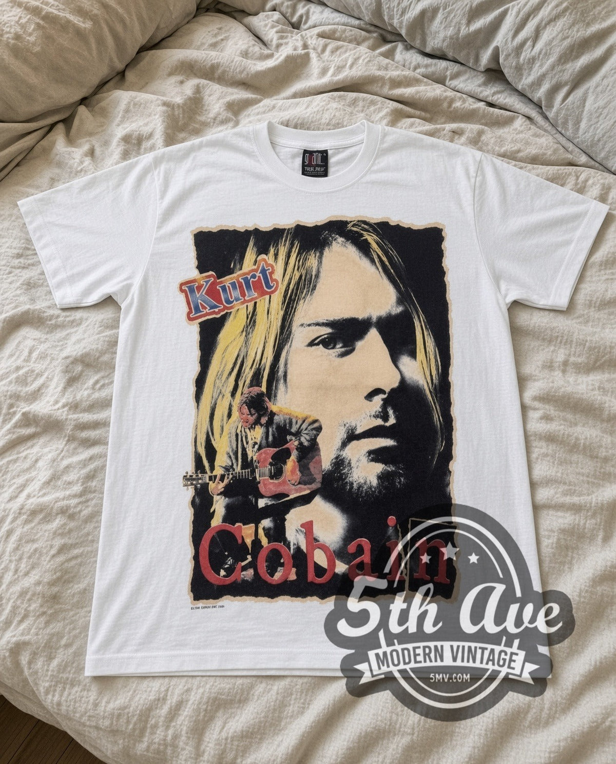 Kurt Cobain Portrait vintage band t-shirt in white laid flat on a bed, front artwork