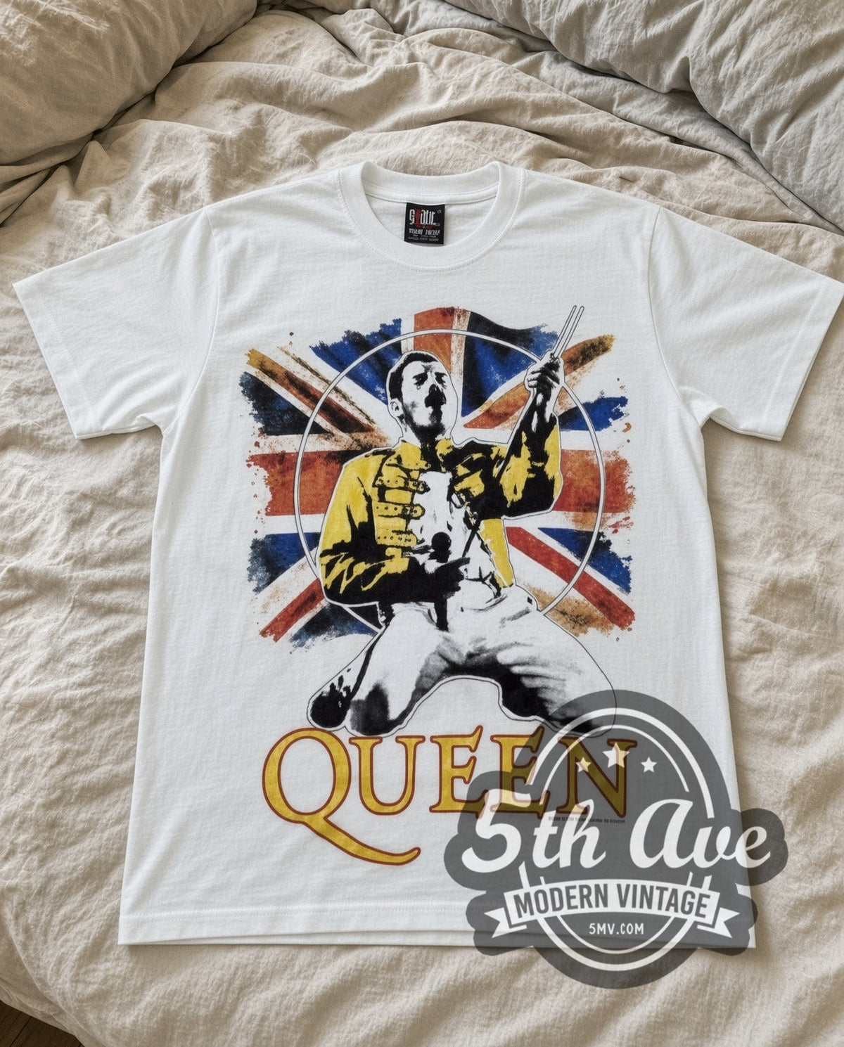 Queen Freddie Union Jack vintage band t-shirt in white laid flat on a bed, front artwork