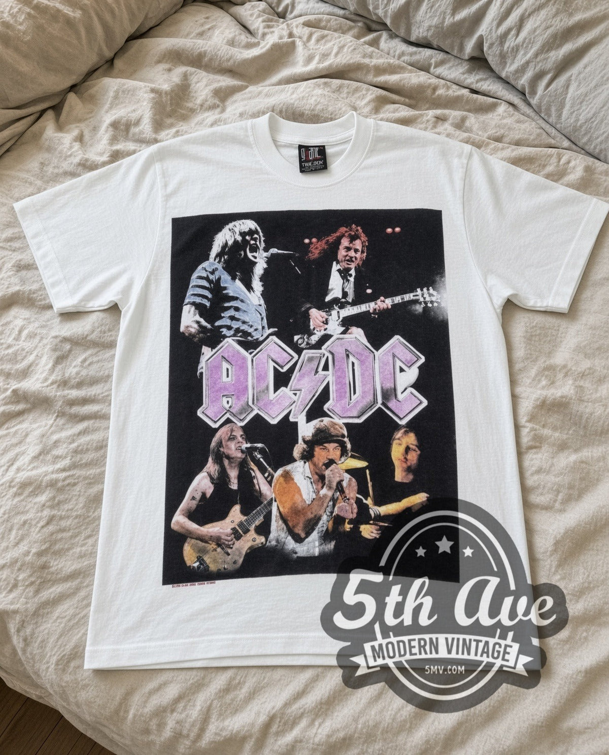 AC/DC Purple Logo Band vintage band t-shirt in white laid flat on a bed, front artwork