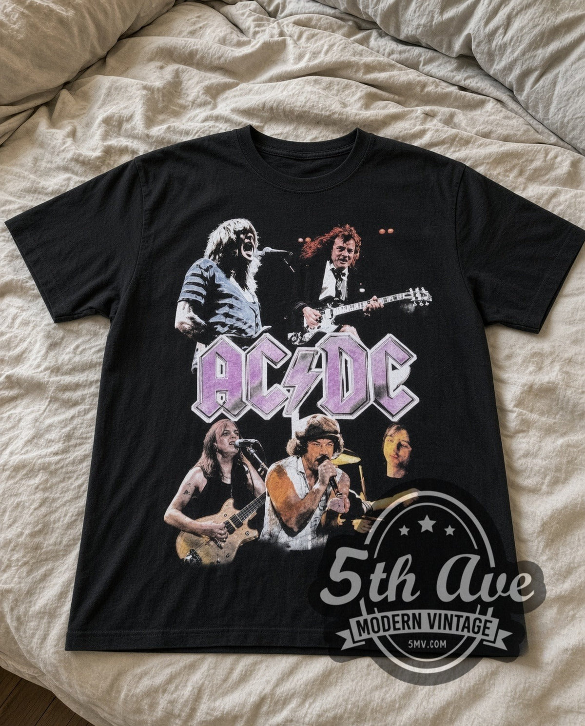 AC/DC Purple Logo Band vintage band t-shirt in black laid flat on a bed, front artwork