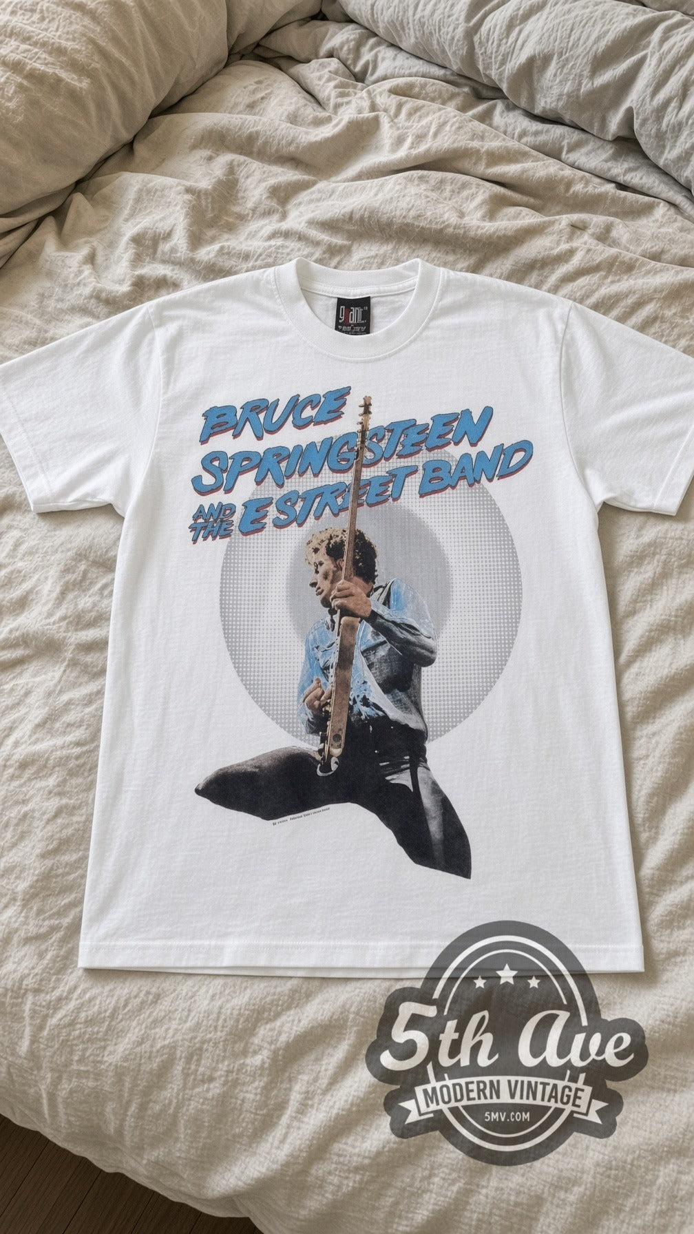 Bruce Springsteen E Street Band vintage band t-shirt in white laid flat on a bed, front artwork
