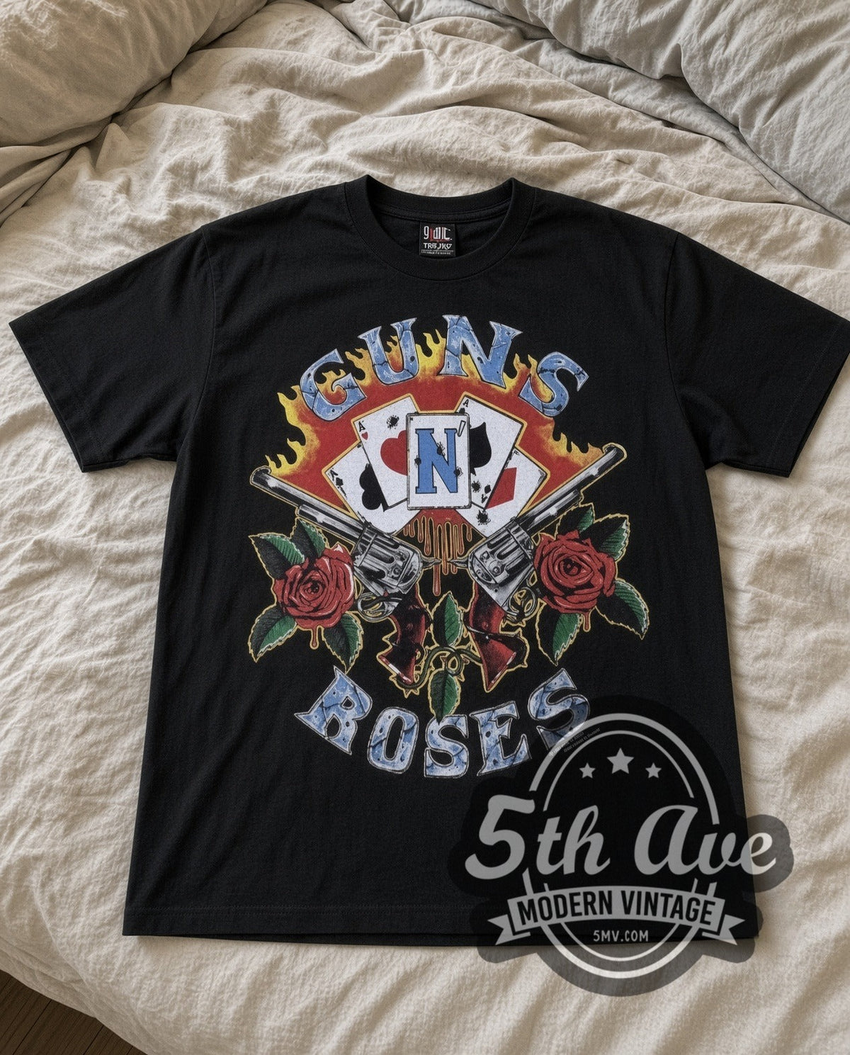 Guns N Roses Guns and Roses vintage band t-shirt in black laid flat on a bed, front artwork