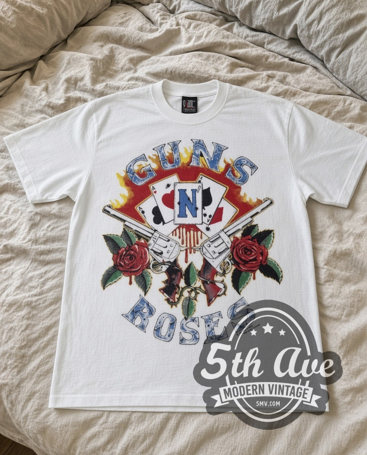Guns N Roses Guns and Roses vintage band t-shirt in white laid flat on a bed, front artwork