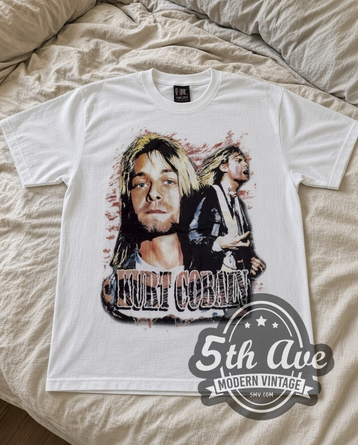Kurt Cobain With Band vintage band t-shirt in white laid flat on a bed, front artwork