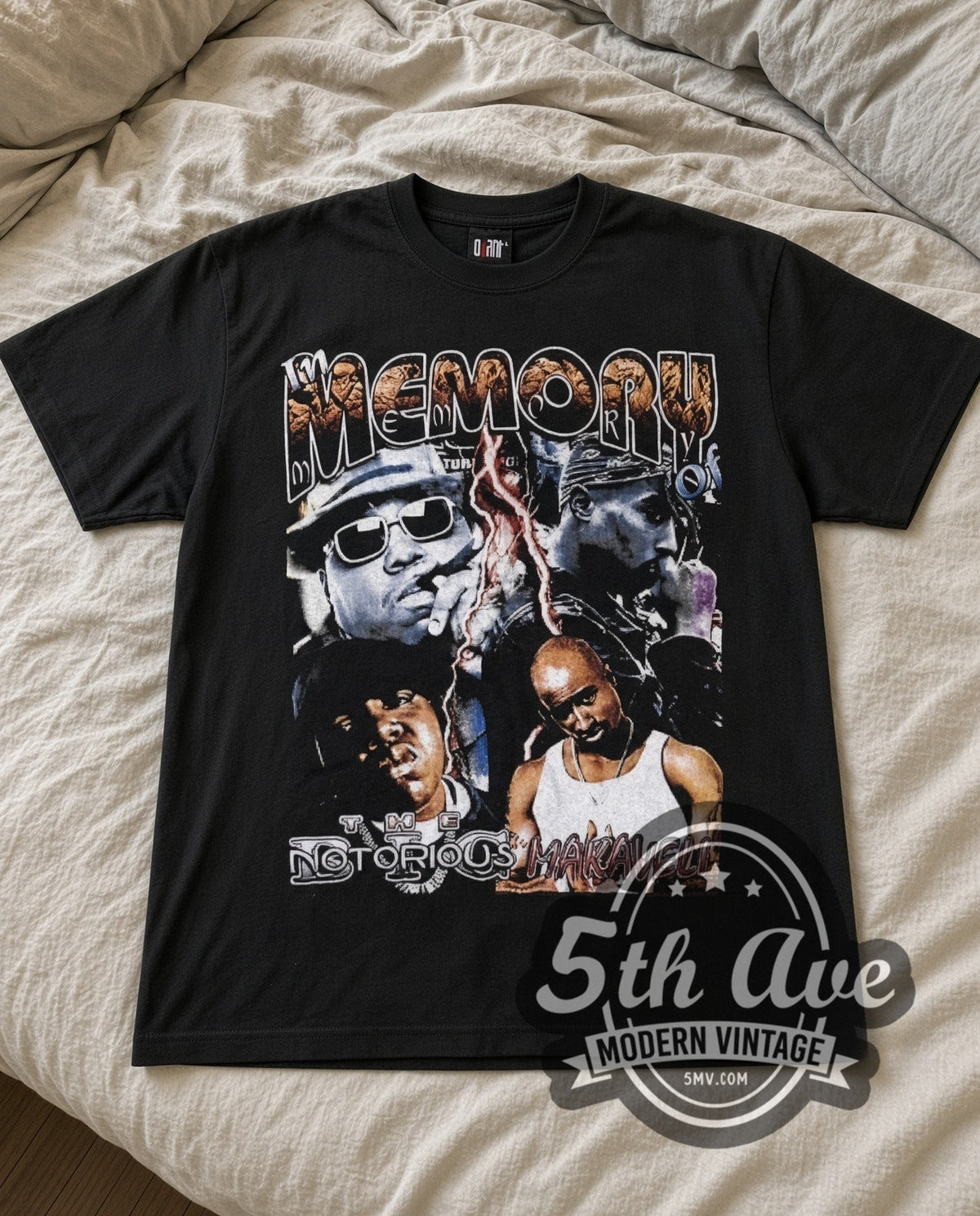 The Notorious B.I.G. & Makaveli In Memory Of vintage rap tee in black laid flat on a bed, front artwork