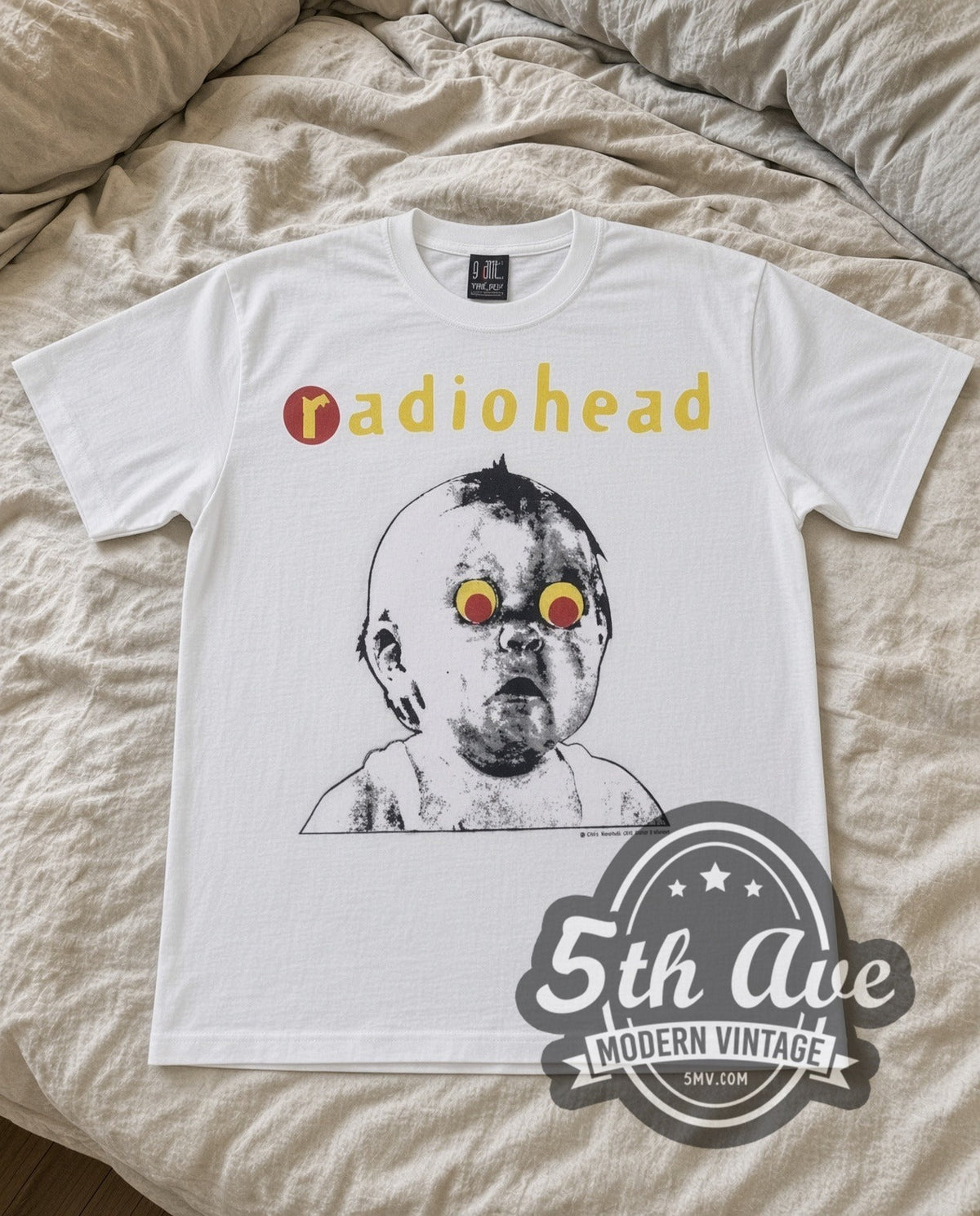 Radiohead Pablo Honey vintage band t-shirt in white laid flat on a bed, front artwork