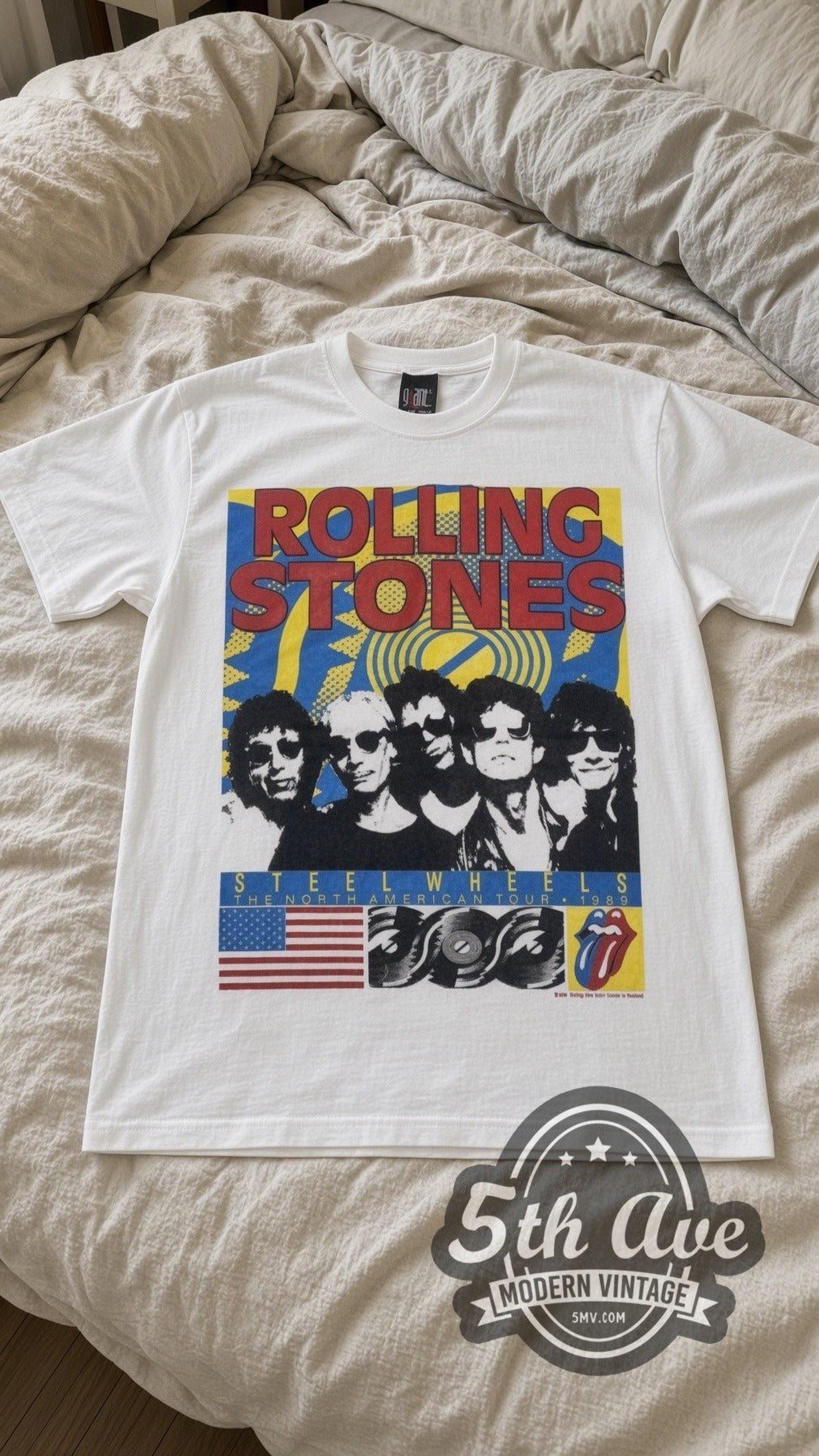 Rolling Stones Steel Wheels Band vintage band t-shirt in white laid flat on a bed, front artwork