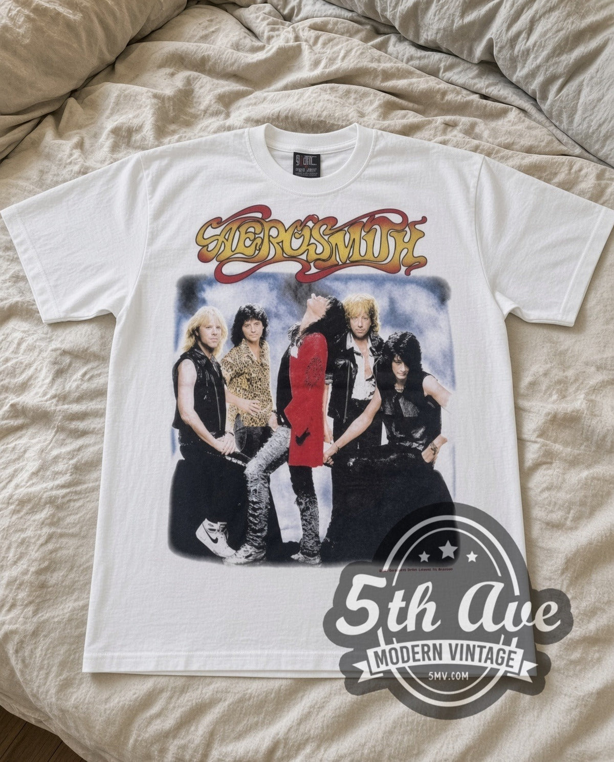 Aerosmith Band Photo vintage band t-shirt in white laid flat on a bed, front artwork
