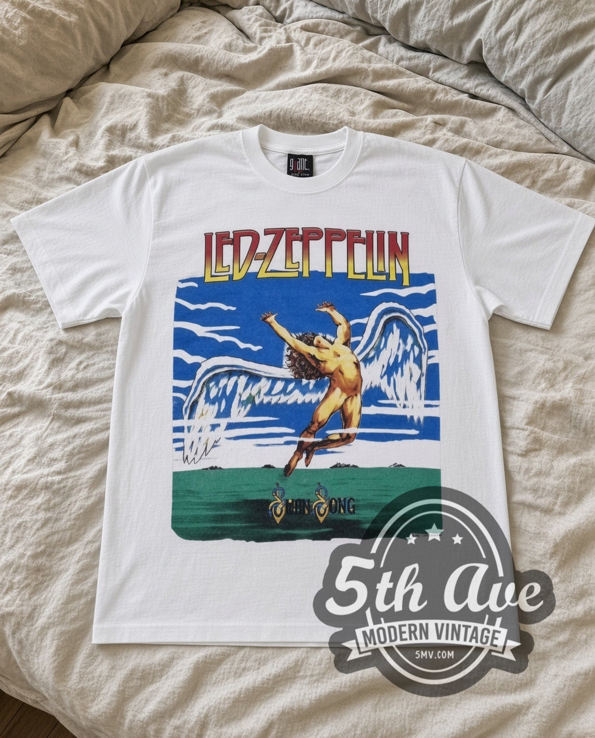 Led Zeppelin Swan Song vintage band t-shirt in white laid flat on a bed, front artwork