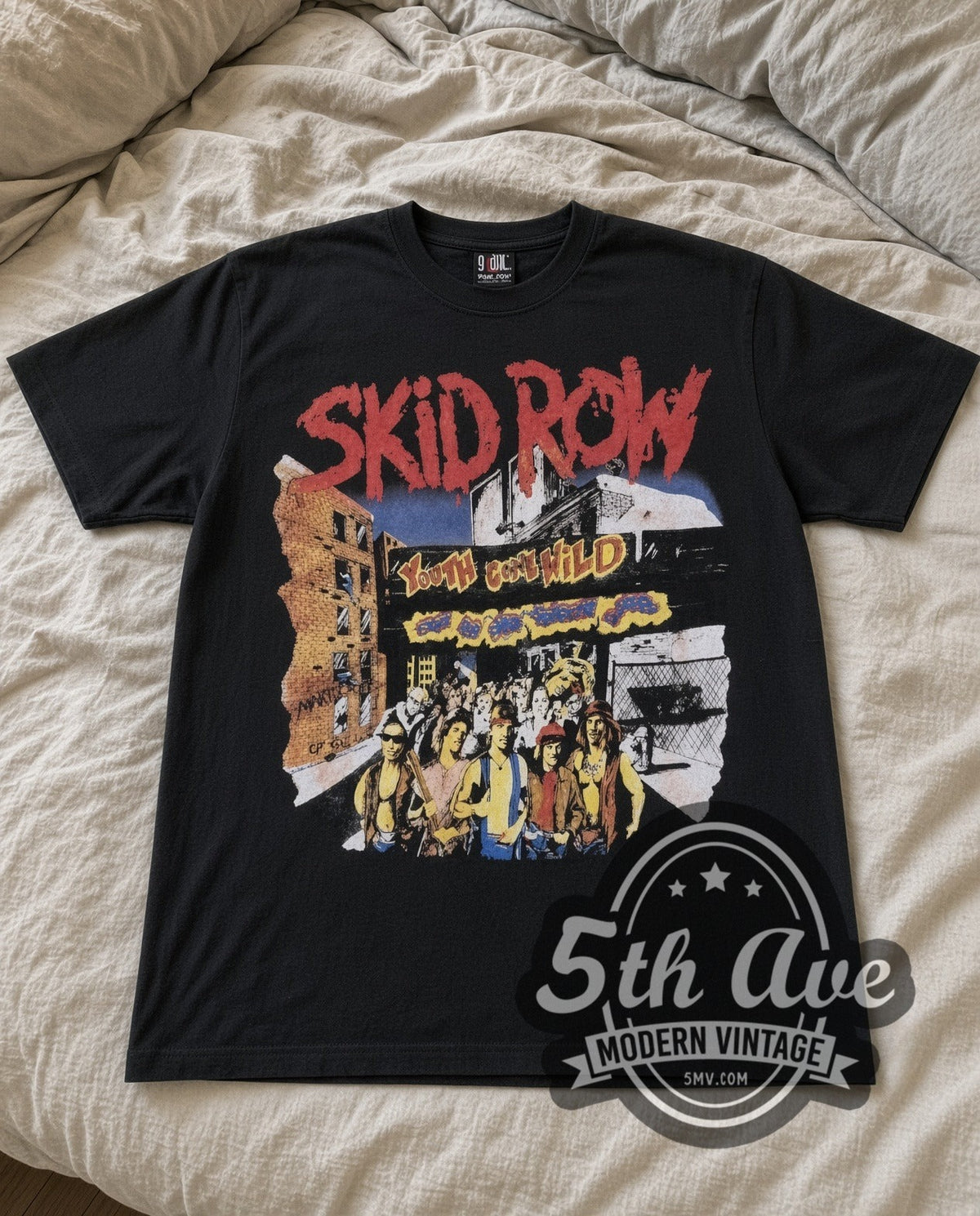 Skid Row Youth Gone Wild vintage band t-shirt in black laid flat on a bed, front artwork