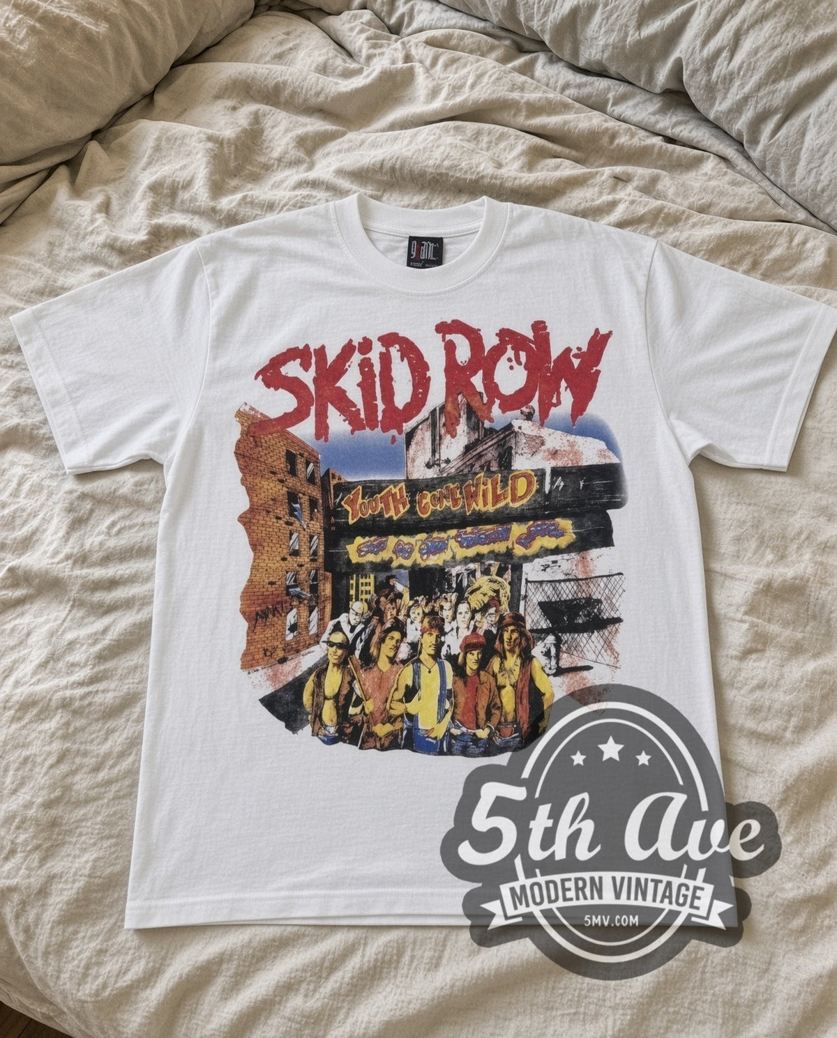 Skid Row Youth Gone Wild vintage band t-shirt in white laid flat on a bed, front artwork