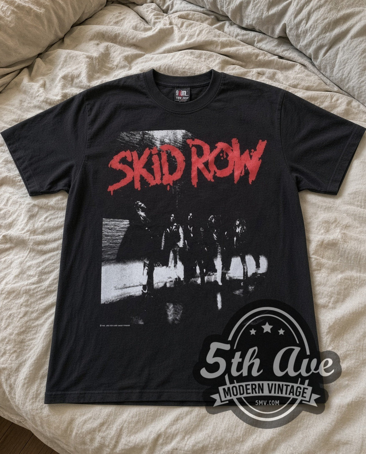 Skid Row Red Logo vintage band t-shirt laid flat on a bed, front artwork