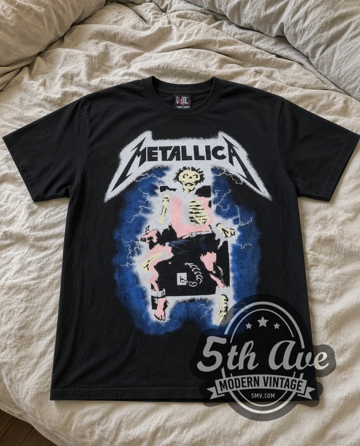 Metallica Lightning vintage band t-shirt laid flat on a bed, front artwork