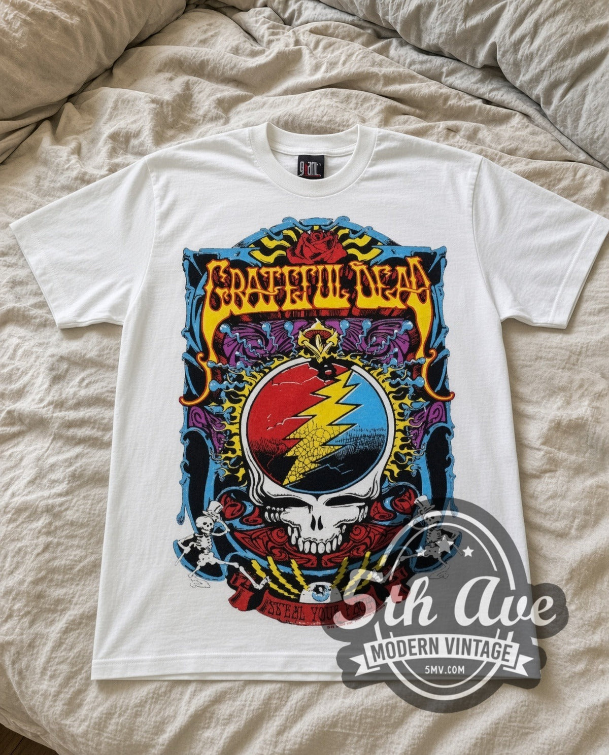 Grateful Dead Steal Your Face vintage band t-shirt in white laid flat on a bed, front artwork