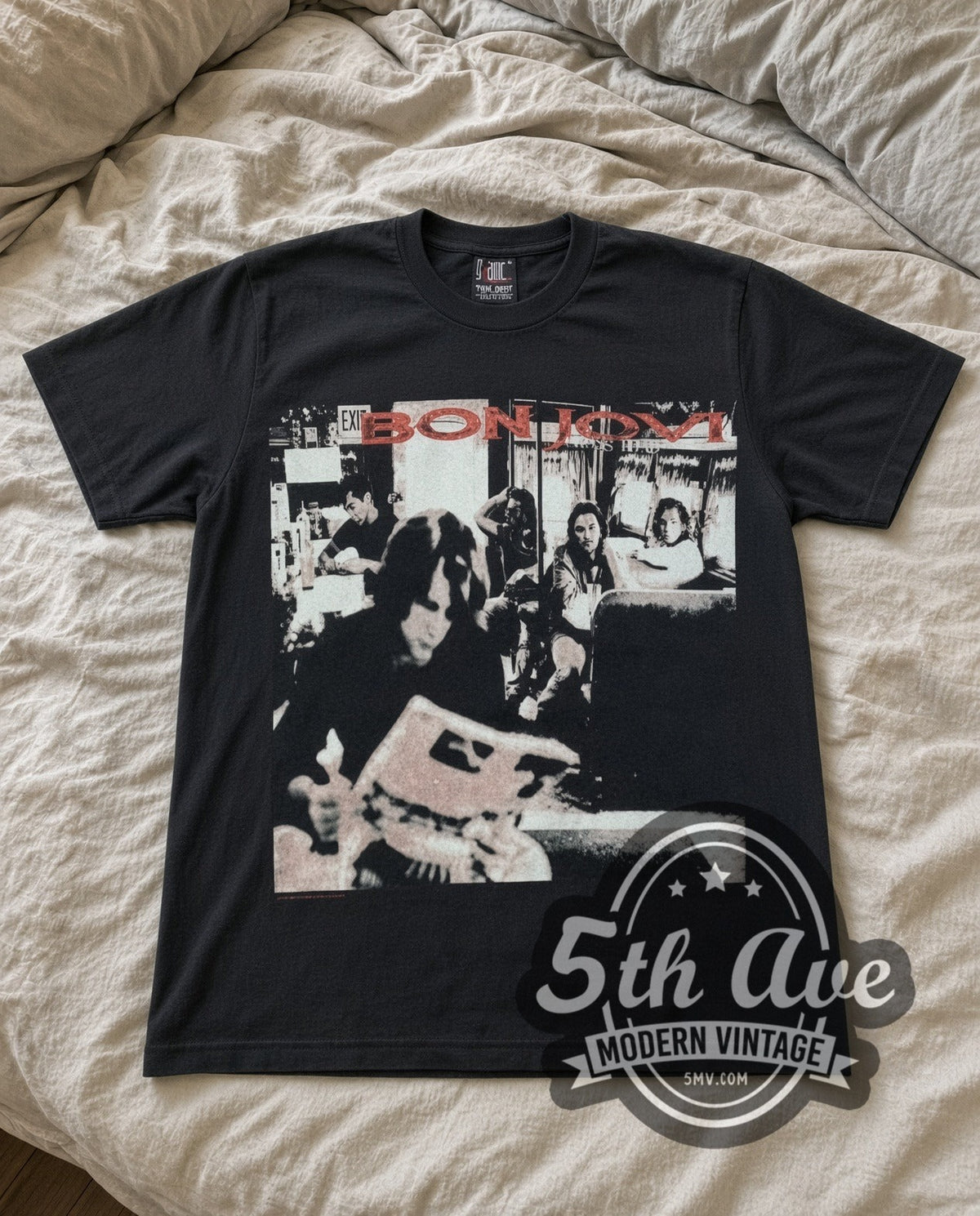 Bon Jovi Live vintage band t-shirt in black laid flat on a bed, front artwork