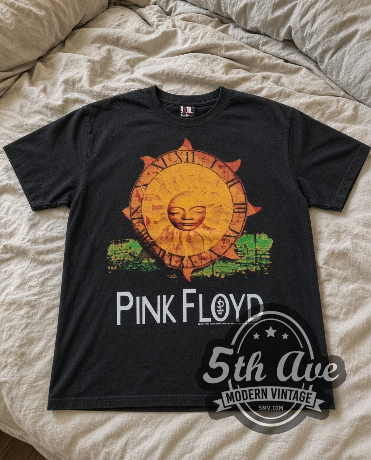 Pink Floyd Sun vintage band t-shirt in black laid flat on a bed, front artwork
