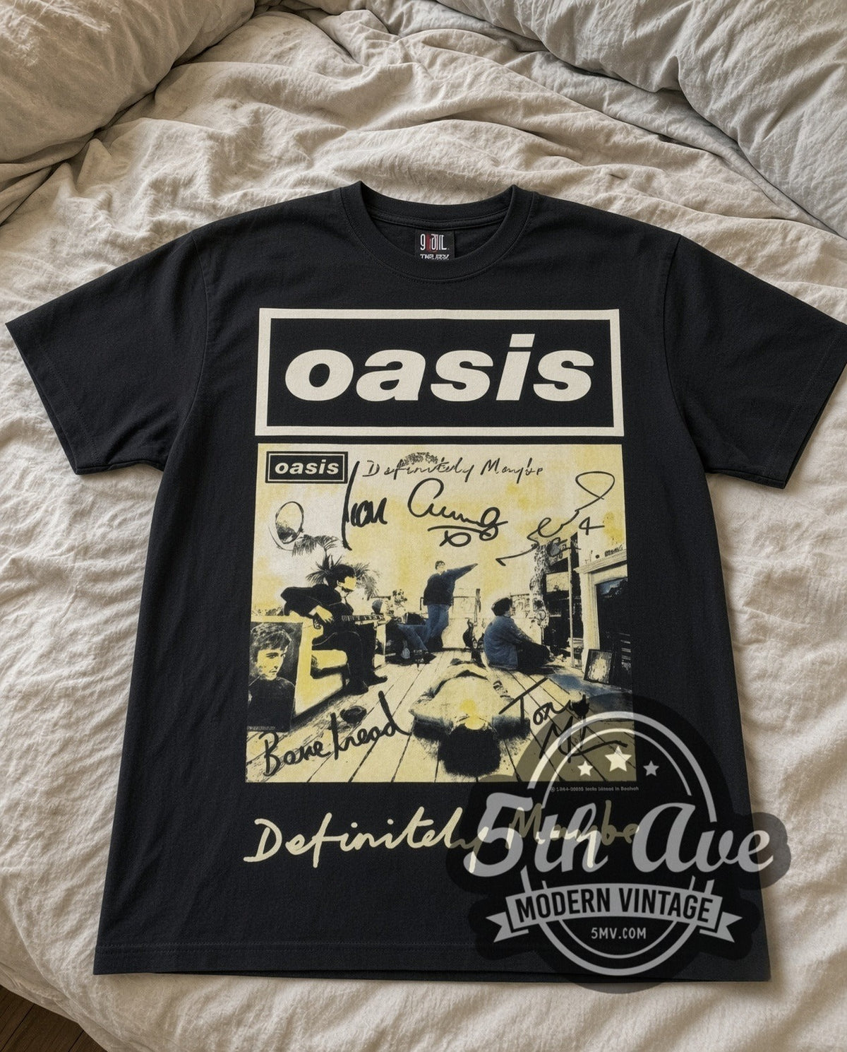 Oasis Definitely Maybe vintage band t-shirt in black laid flat on a bed, front artwork