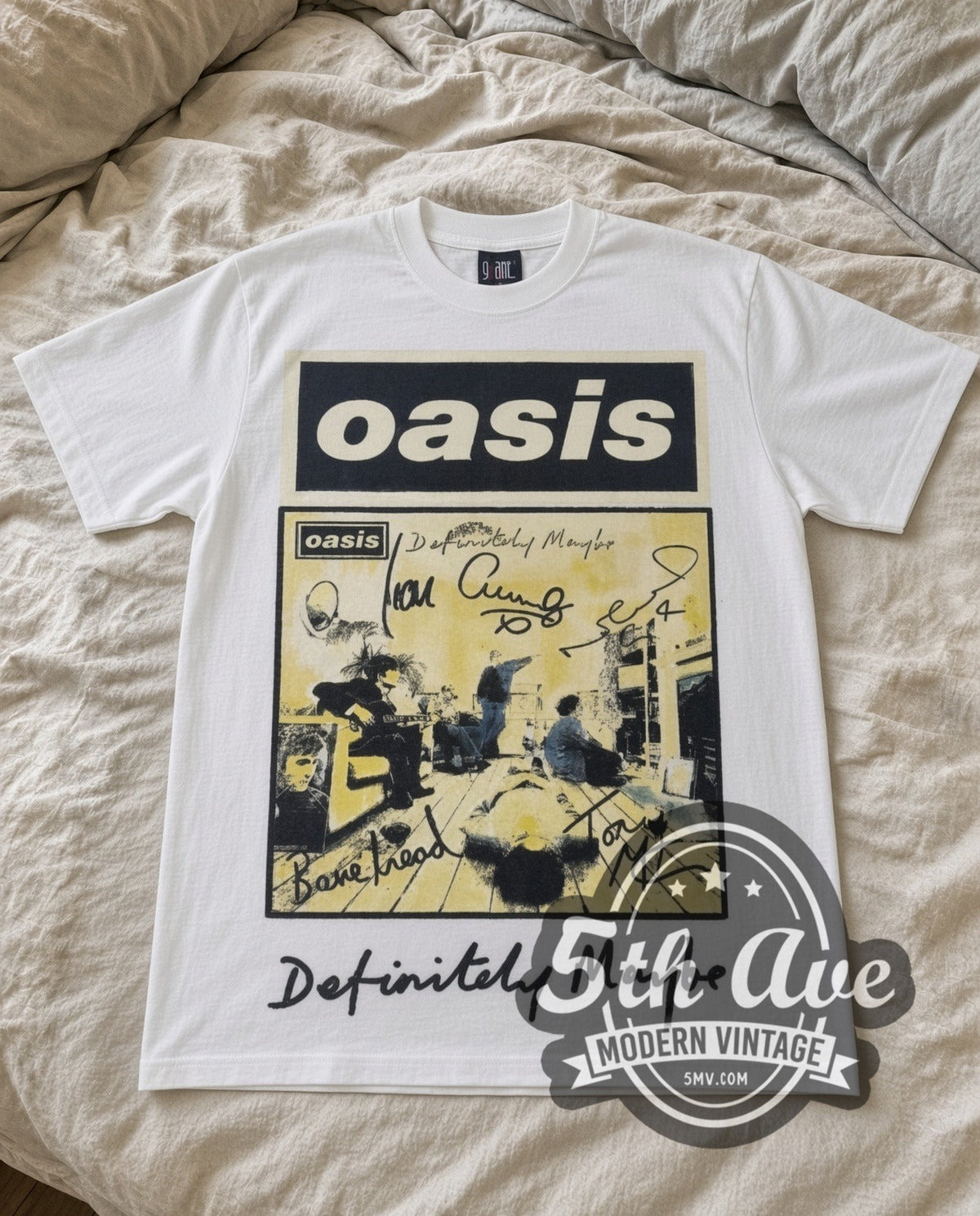 Oasis Definitely Maybe vintage band t-shirt in white laid flat on a bed, front artwork