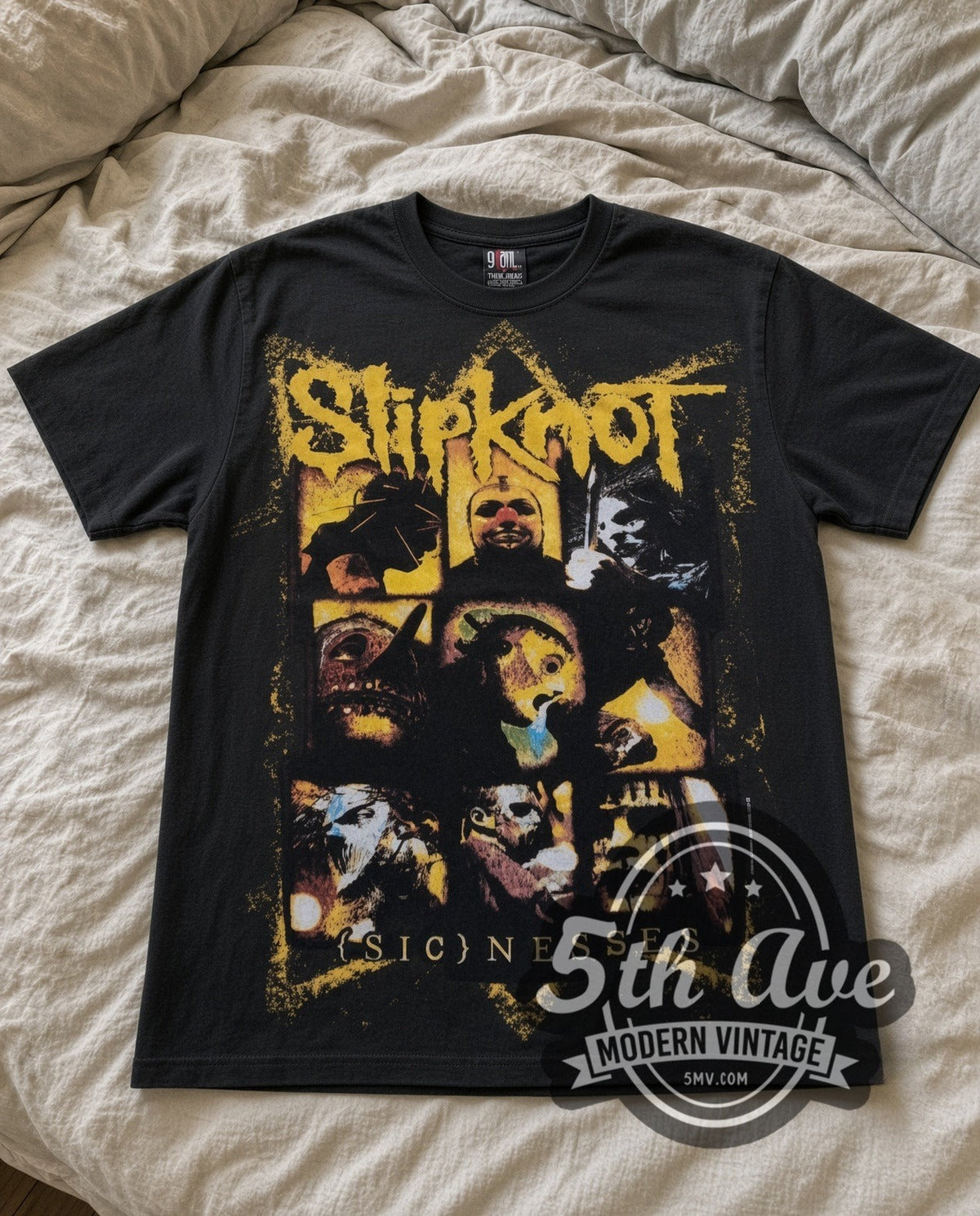 Slipknot Masks vintage band t-shirt in black laid flat on a bed, front artwork