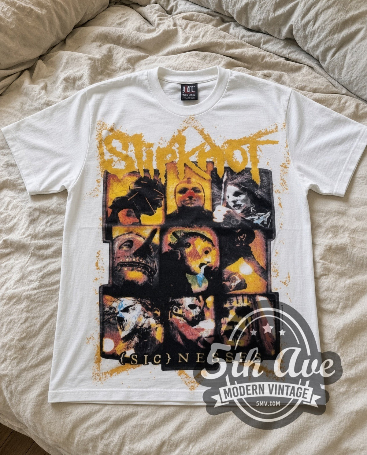 Slipknot Masks vintage band t-shirt in white laid flat on a bed, front artwork