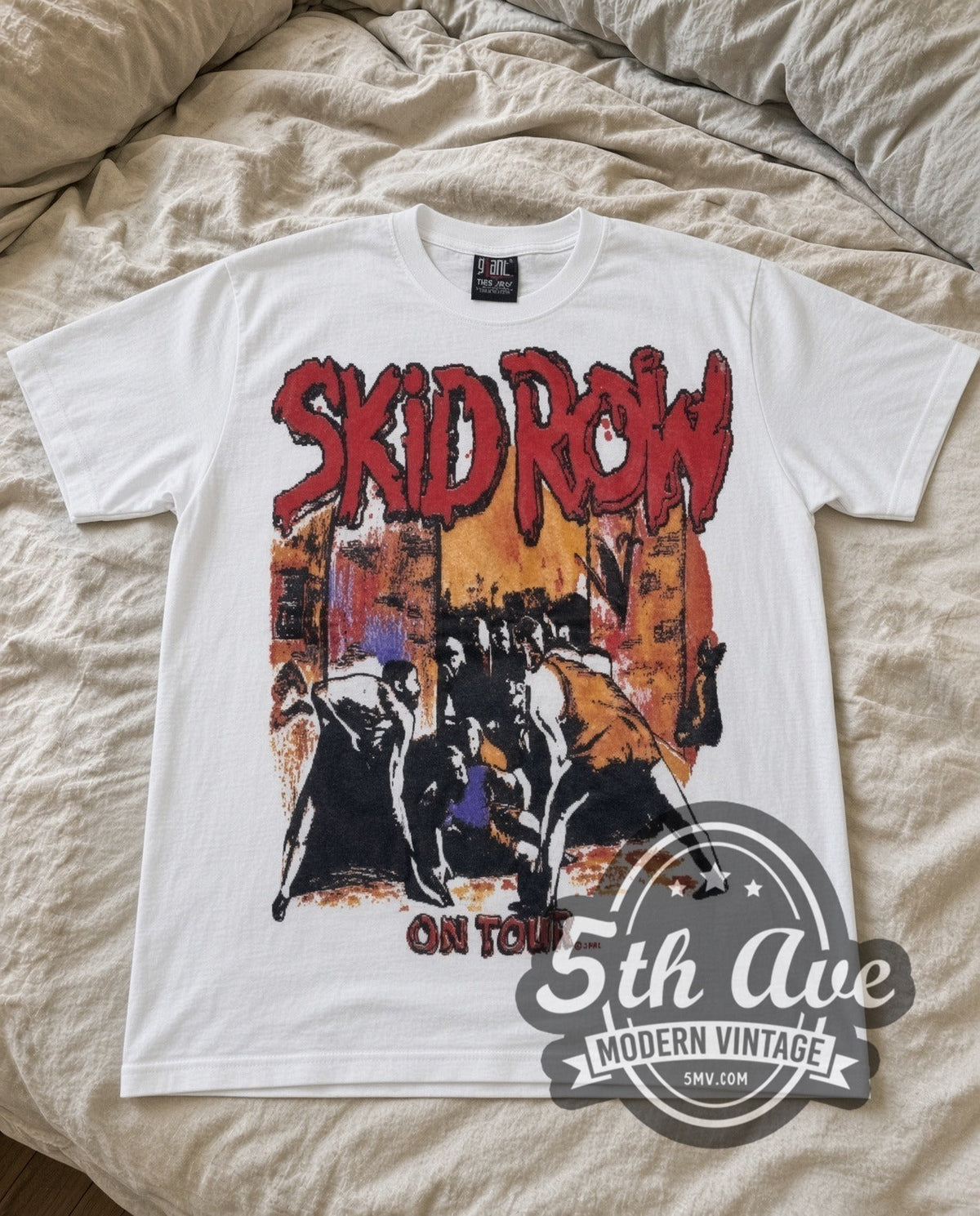 Skid Row On Tour vintage band t-shirt in white laid flat on a bed, front artwork