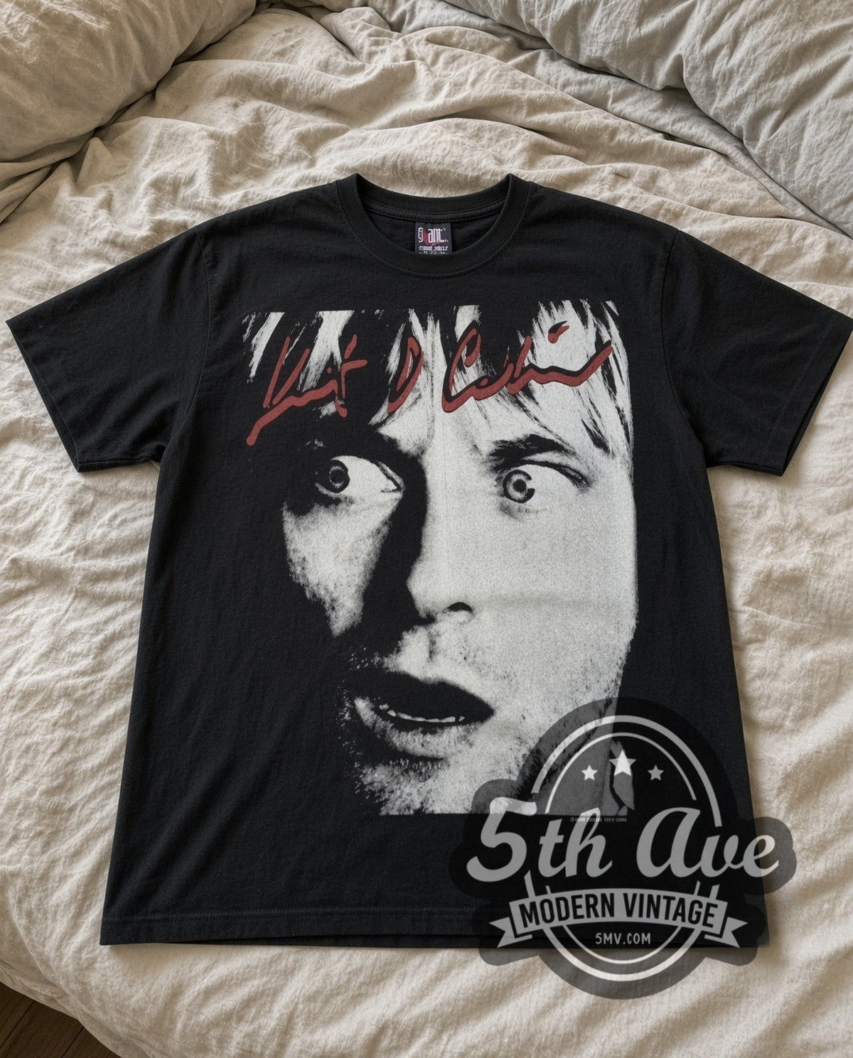 Kurt Cobain Wide Eyes vintage band t-shirt laid flat on a bed, front artwork