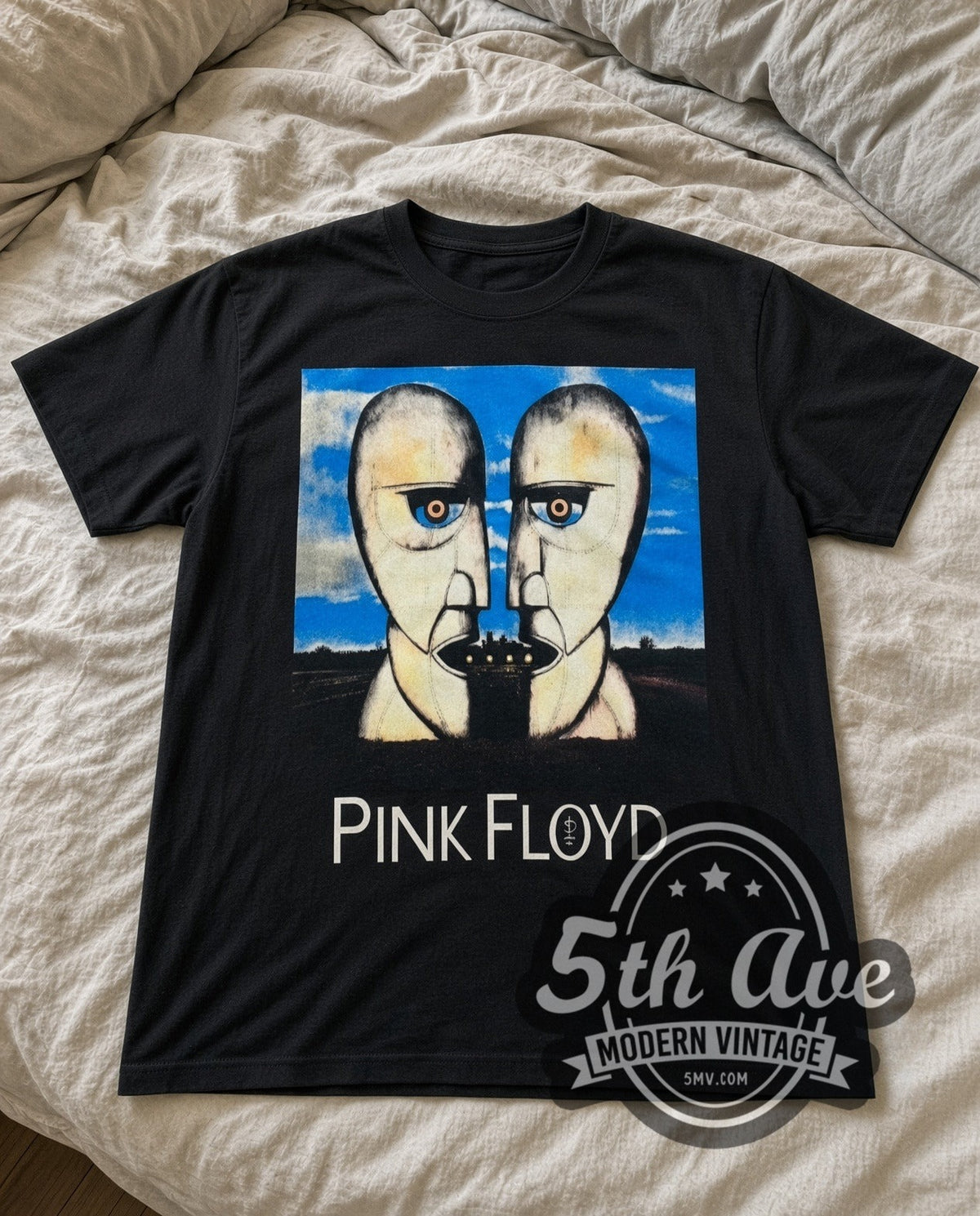Pink Floyd Division Bell vintage band t-shirt in black laid flat on a bed, front artwork