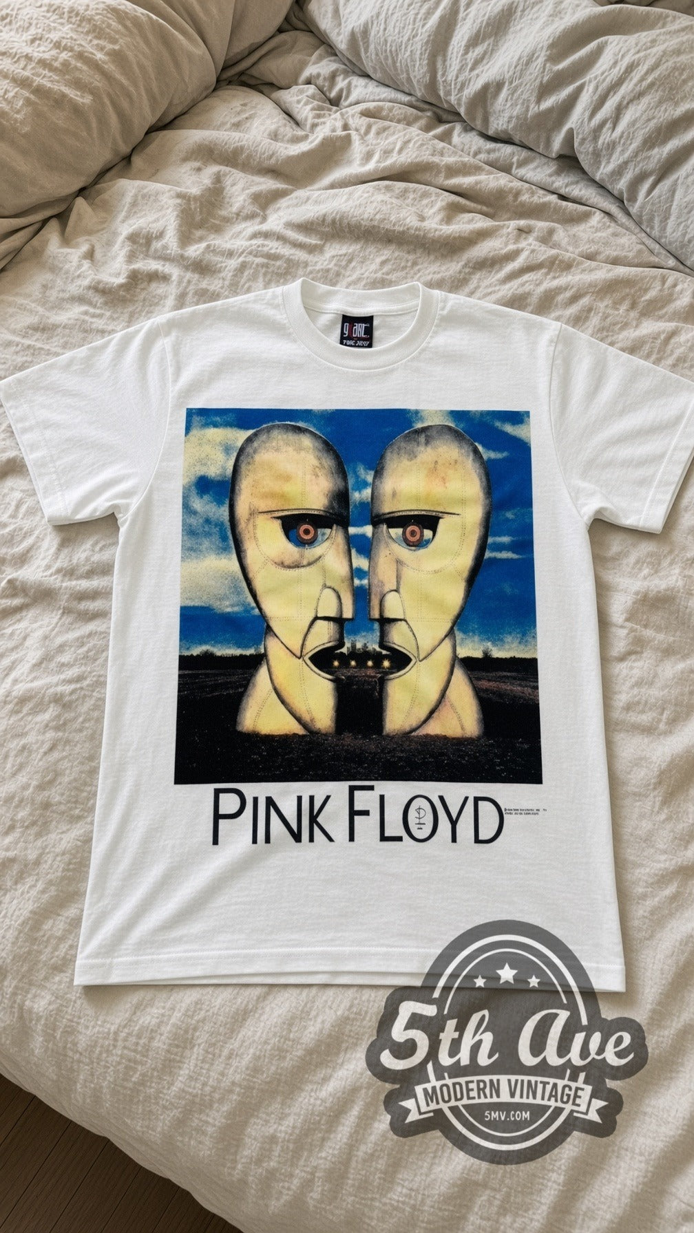 Pink Floyd Division Bell vintage band t-shirt in white laid flat on a bed, front artwork