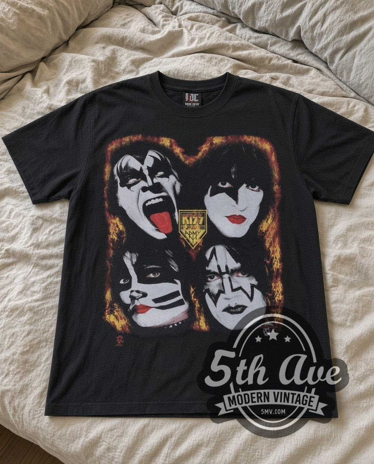 KISS Four Faces vintage band t-shirt laid flat on a bed, front artwork