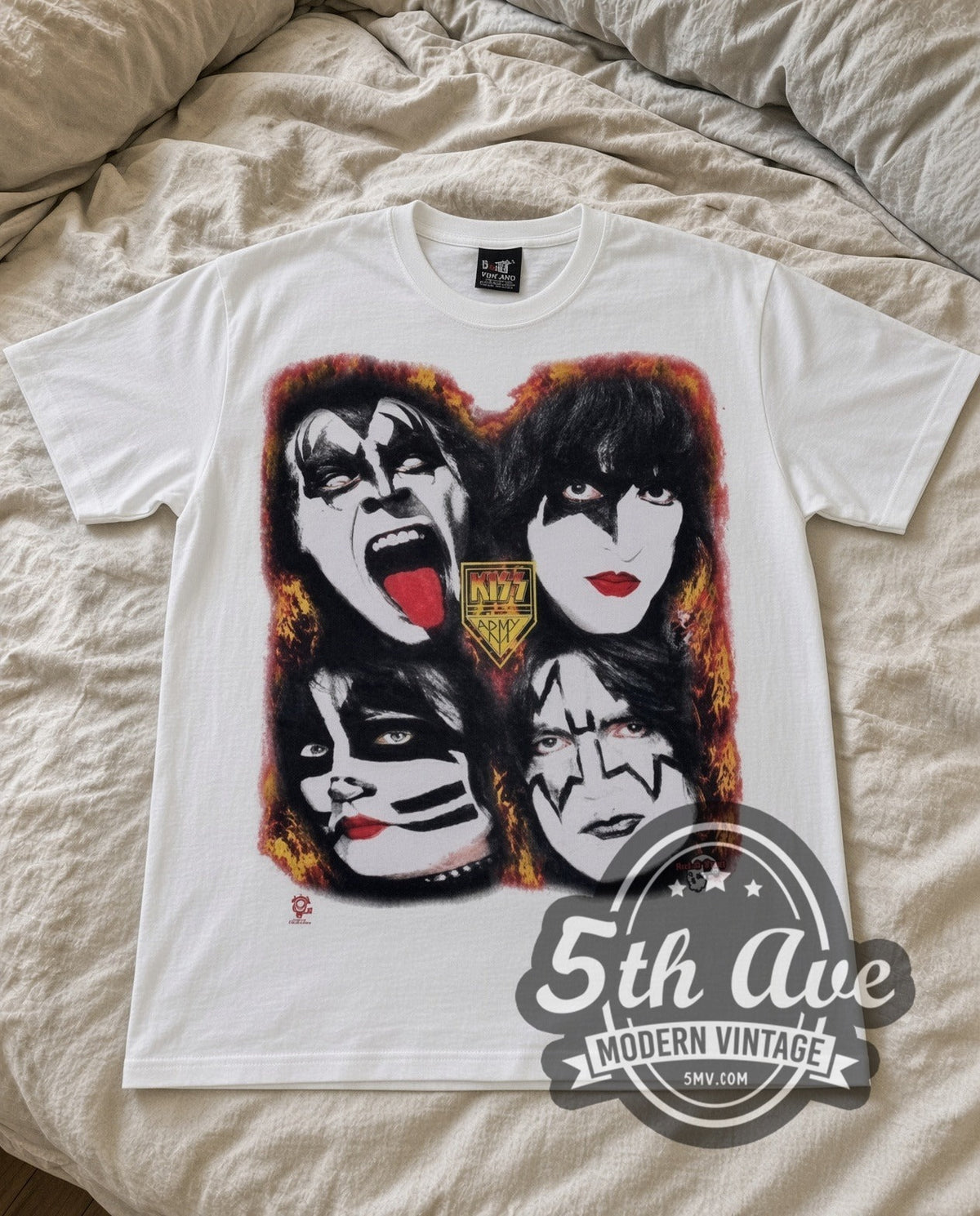 KISS Four Faces vintage band t-shirt in white laid flat on a bed, front artwork