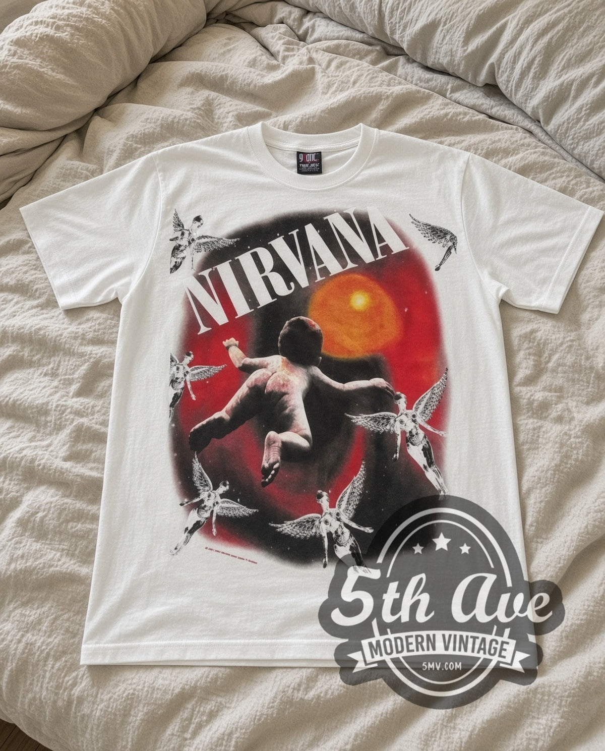 Nirvana Orange Moon vintage band t-shirt in white laid flat on a bed, front artwork