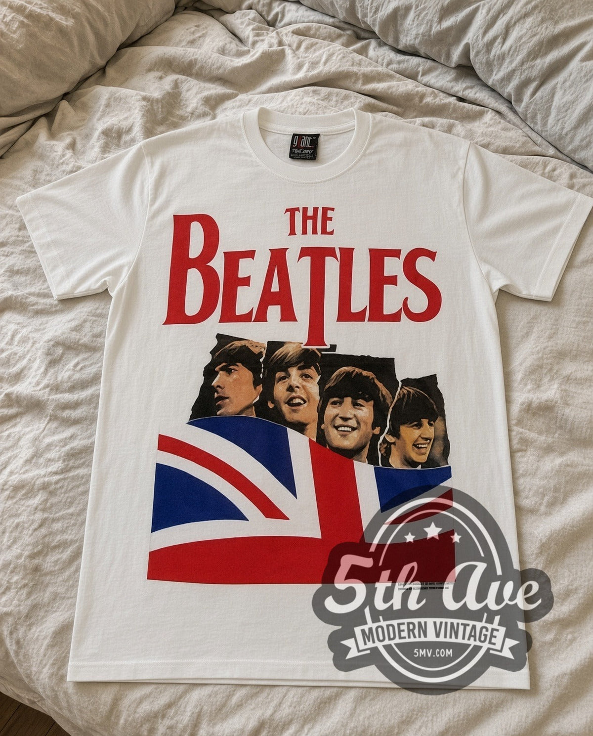 The Beatles Union Jack vintage band t-shirt in white laid flat on a bed, front artwork