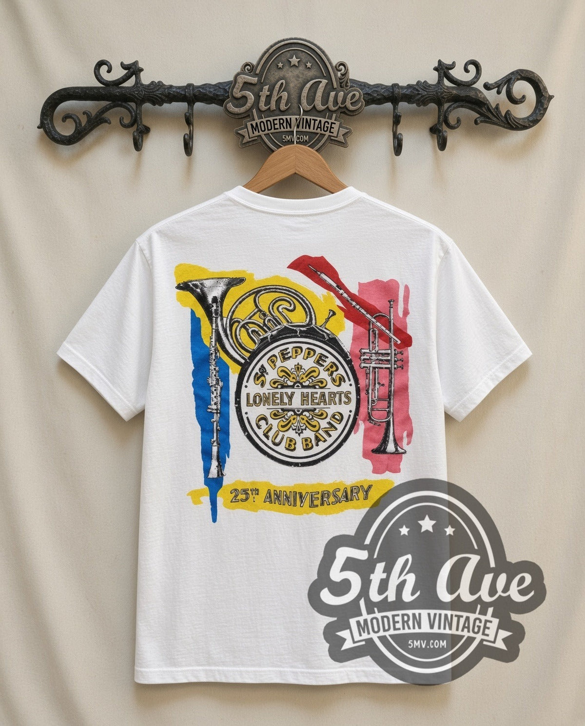 The Beatles Sgt Peppers vintage band t-shirt in white, back view on a display rack