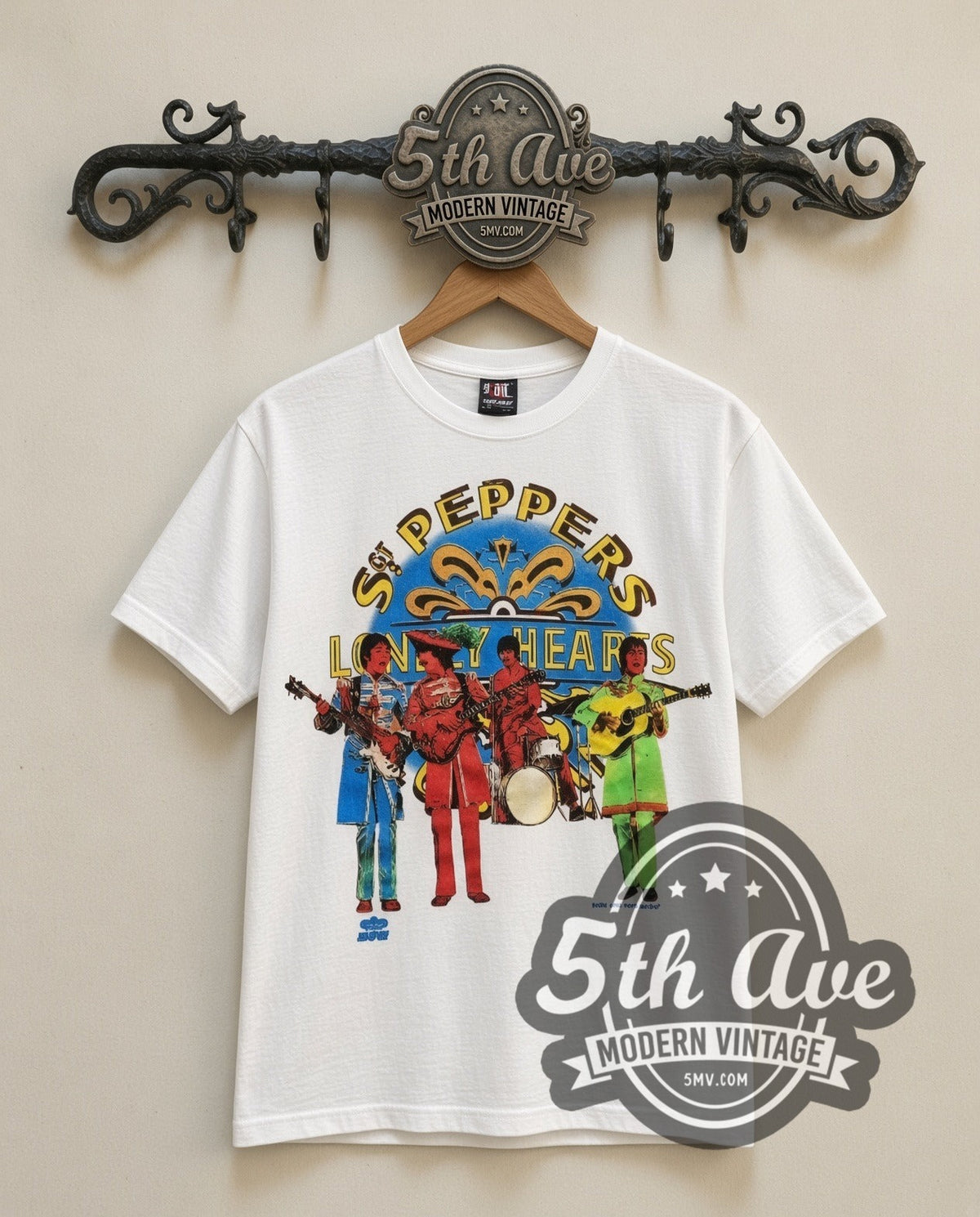 The Beatles Sgt Peppers vintage band t-shirt in white, front view on a display rack
