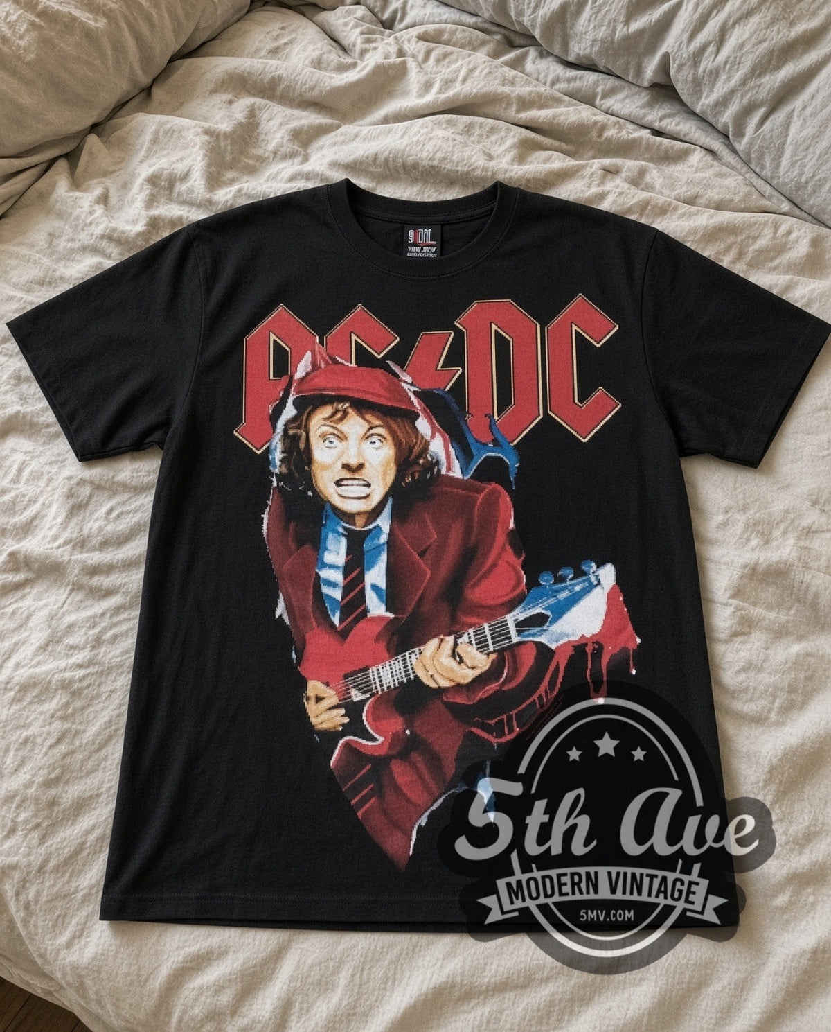 AC/DC Angus Suit vintage band t-shirt in black laid flat on a bed, front artwork